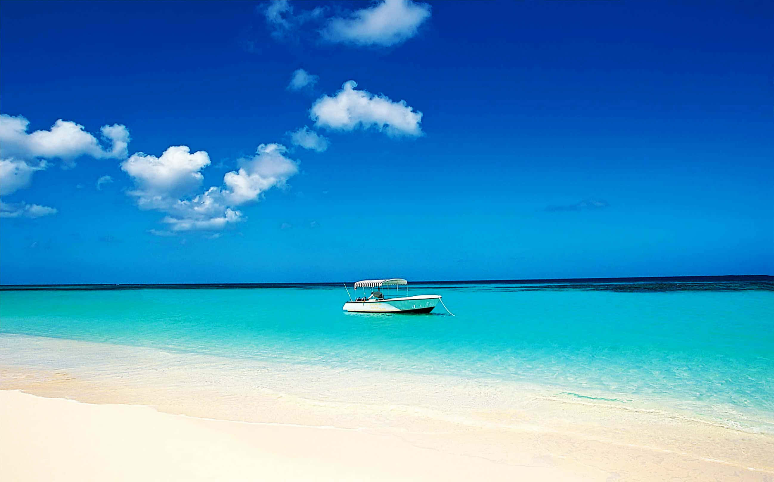Tropical Island, white boat, crystal turquoise water, 2K Desktop Wallpaper