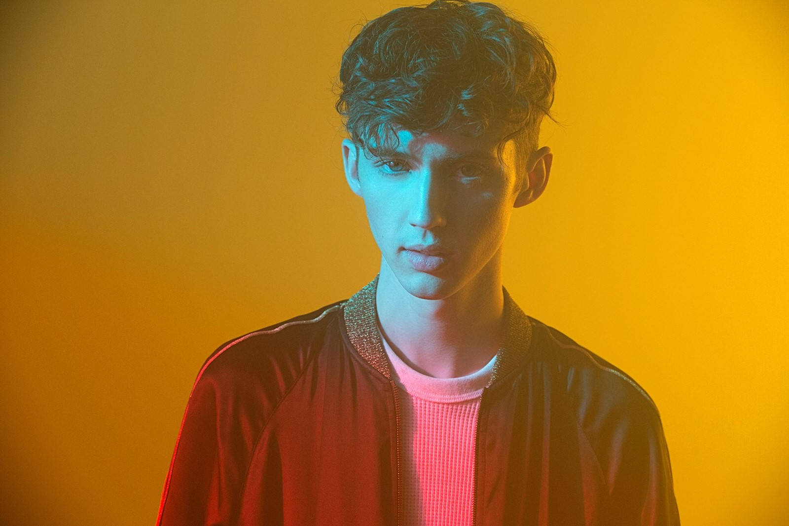 Troye Sivan, curly hair, vibrant orange background, HD Desktop Wallpaper