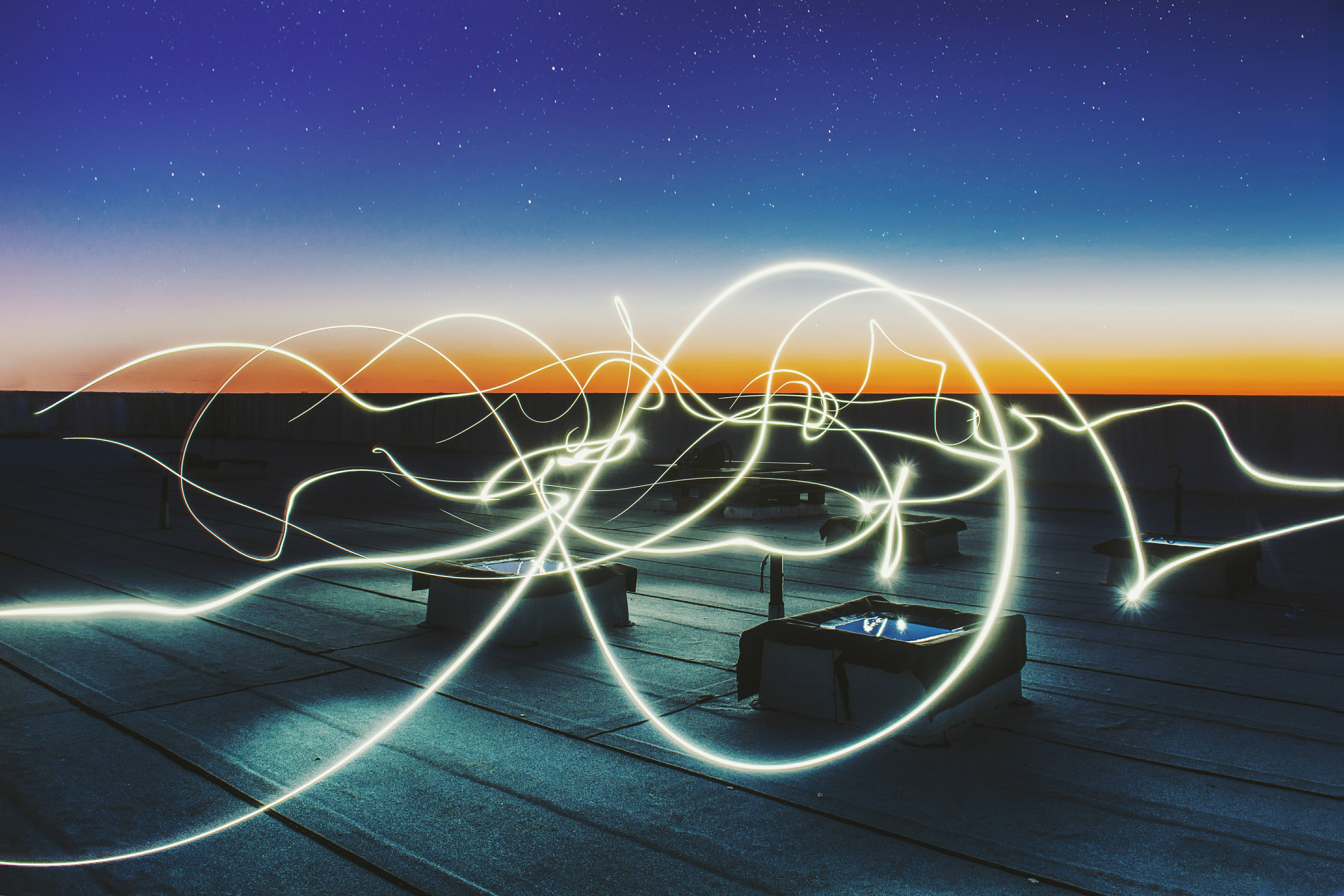 Starry night sky, glowing light trails, rooftop, 5K Desktop Wallpaper