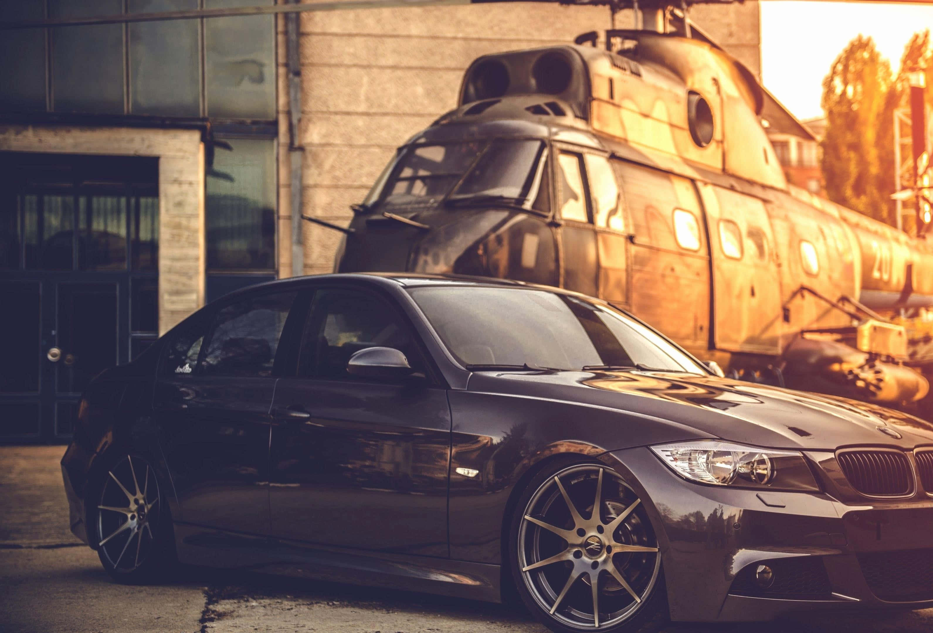 sleek black sports car, gold rims, rusted vintage train, 2K Desktop Wallpaper