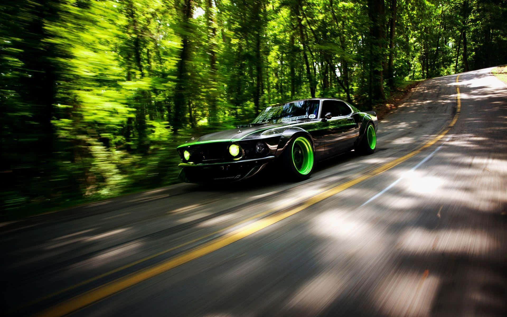 black muscle car, glowing green wheels, sun-dappled forest road, Full HD Desktop Wallpaper