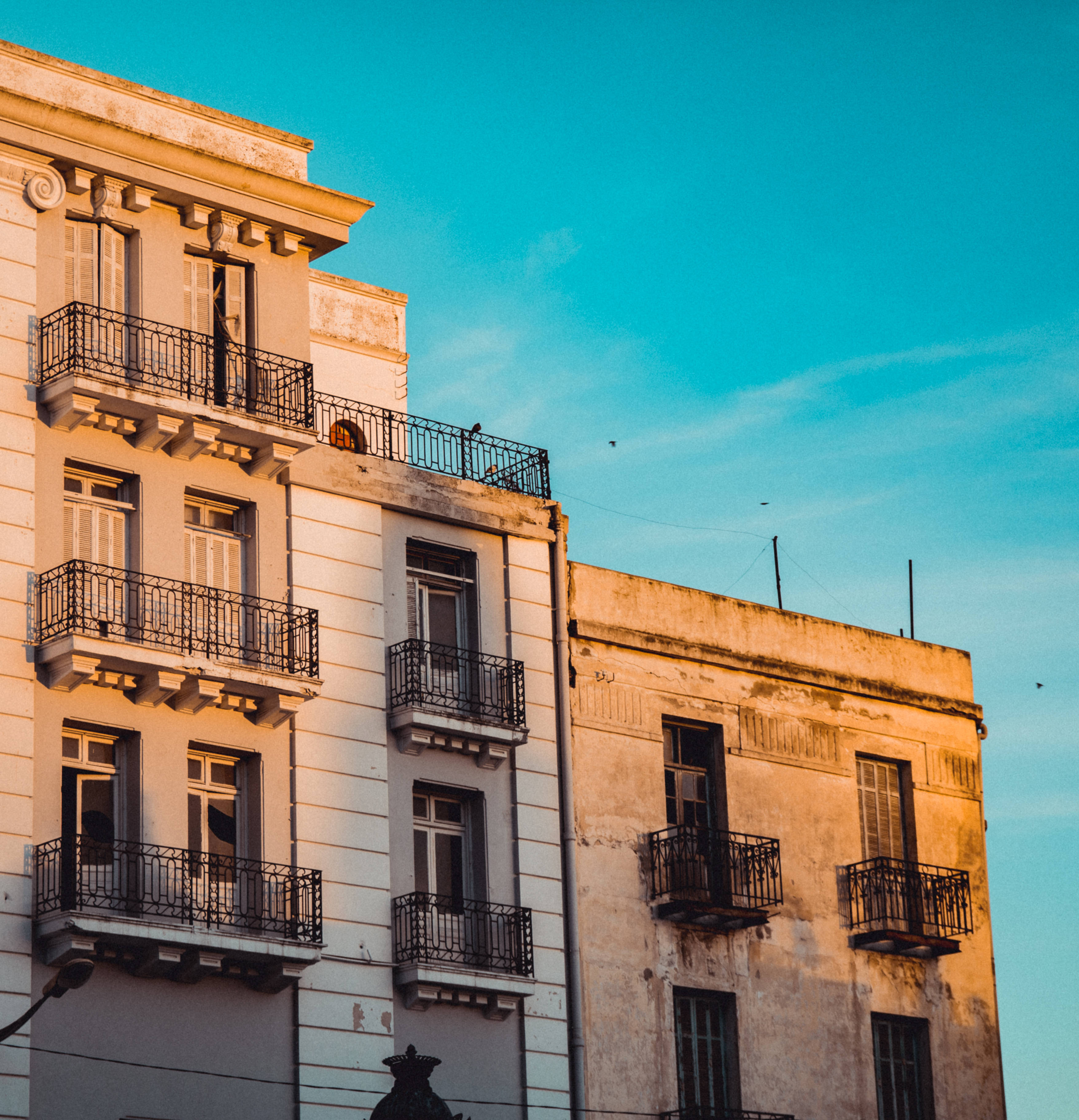 Tunisia, Sunset, weathered European apartment buildings, 2K Phone Wallpaper