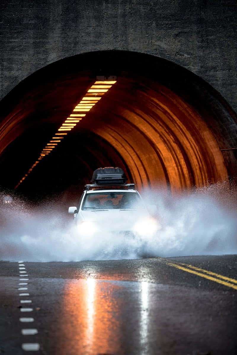 white SUV, flooded tunnel entrance, glowing orange lights, SD Phone Wallpaper