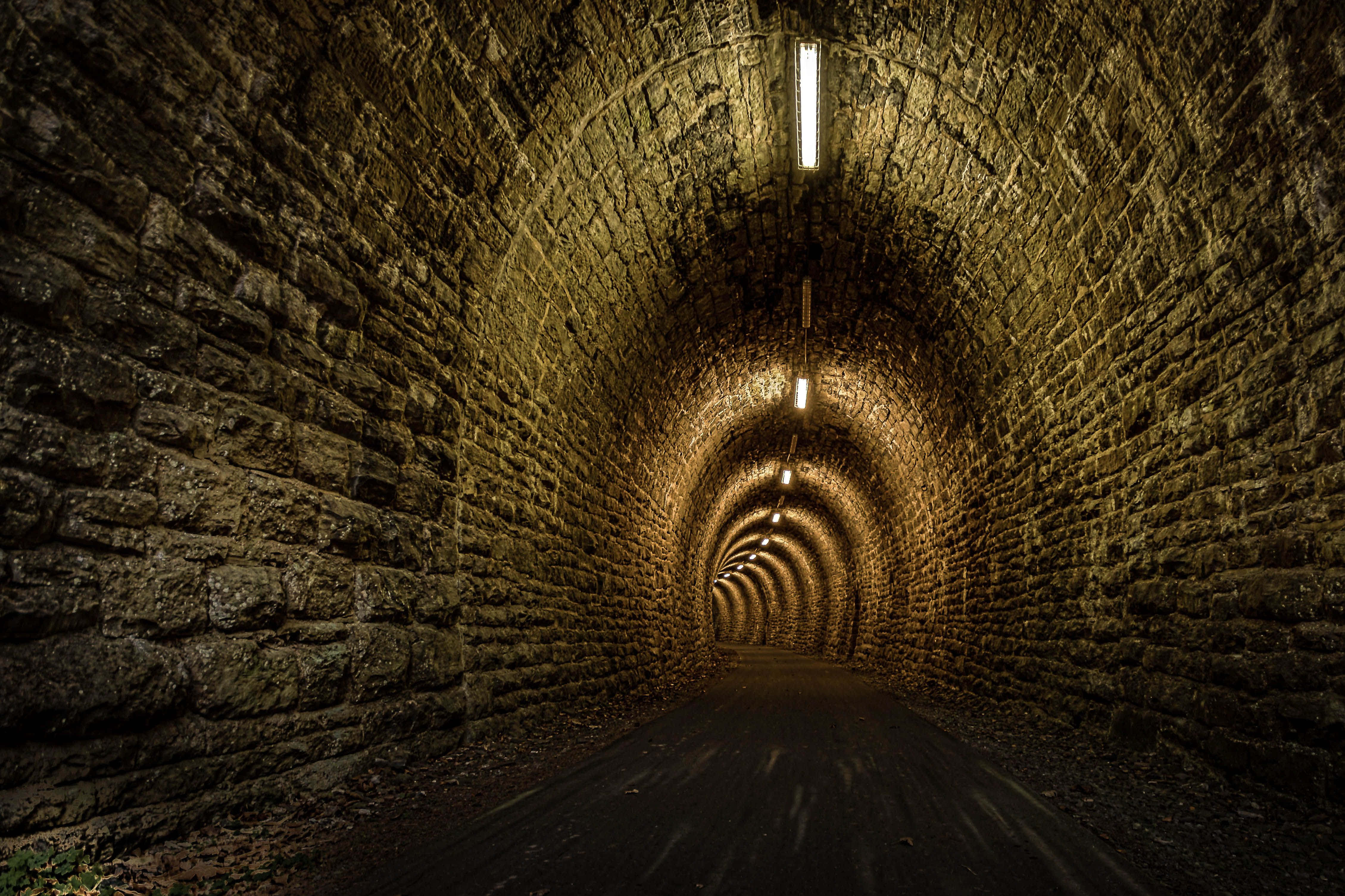 stone tunnel, arched ceilings, warm lights, 4K Desktop Wallpaper