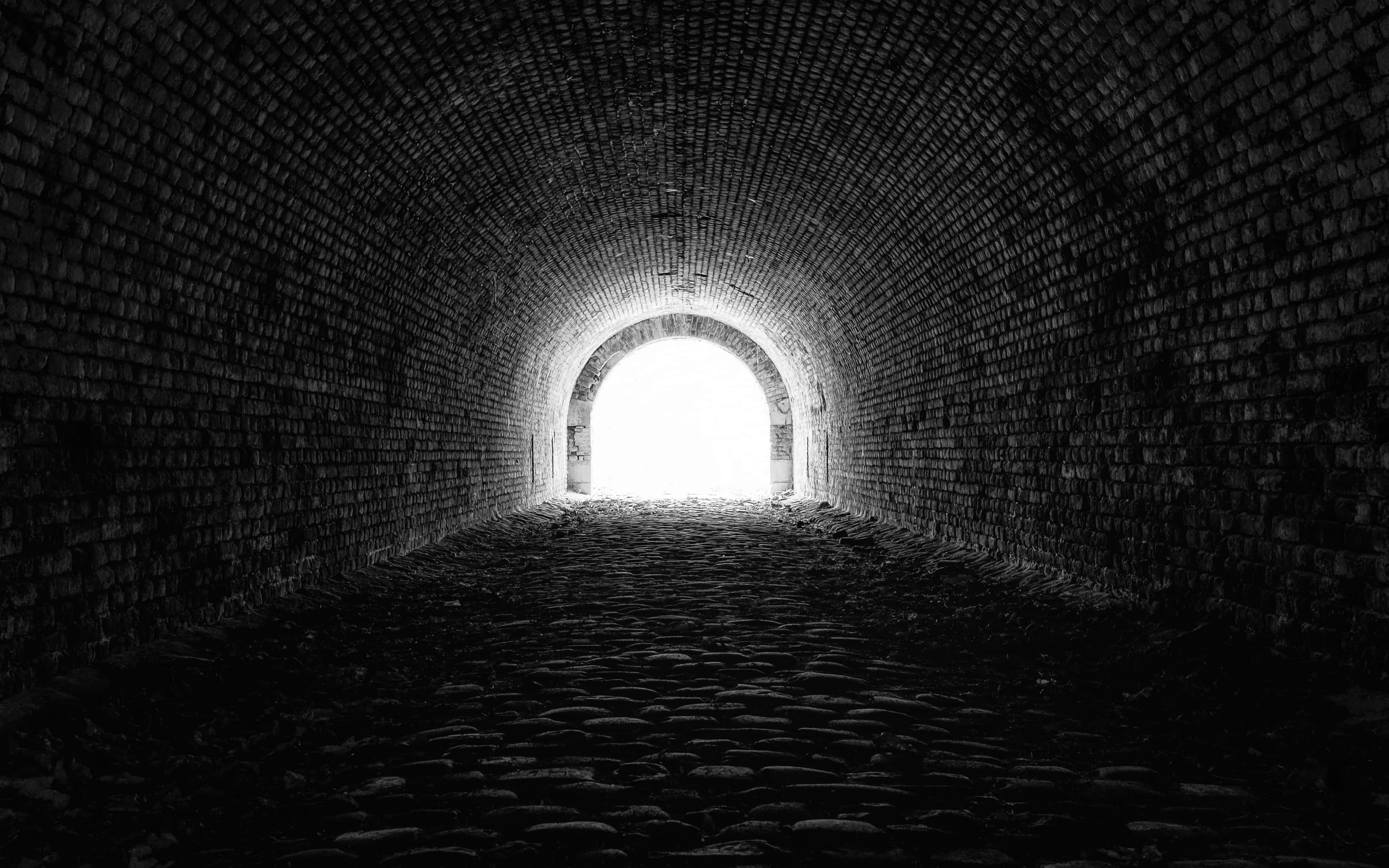 brick tunnel, bright circular exit, black and white view, 4K Desktop Wallpaper