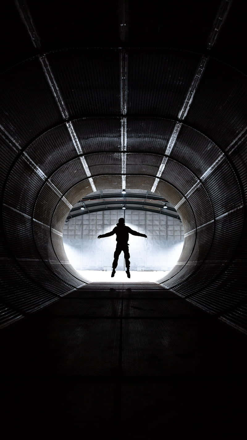 silhouetted figure, dark industrial tunnel, bright exit, HD Phone Wallpaper