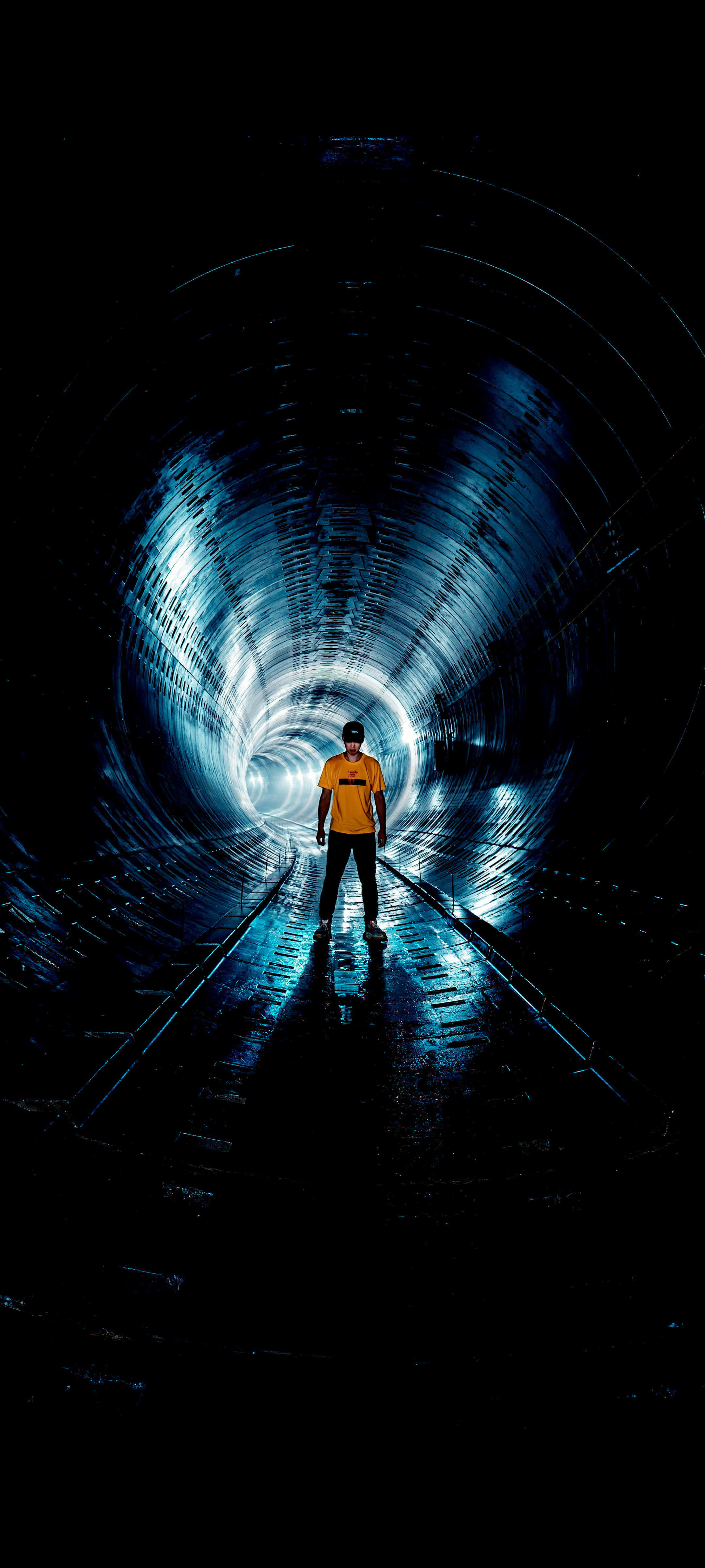 man, yellow shirt, dark blue illuminated tunnel, 4K Phone Wallpaper