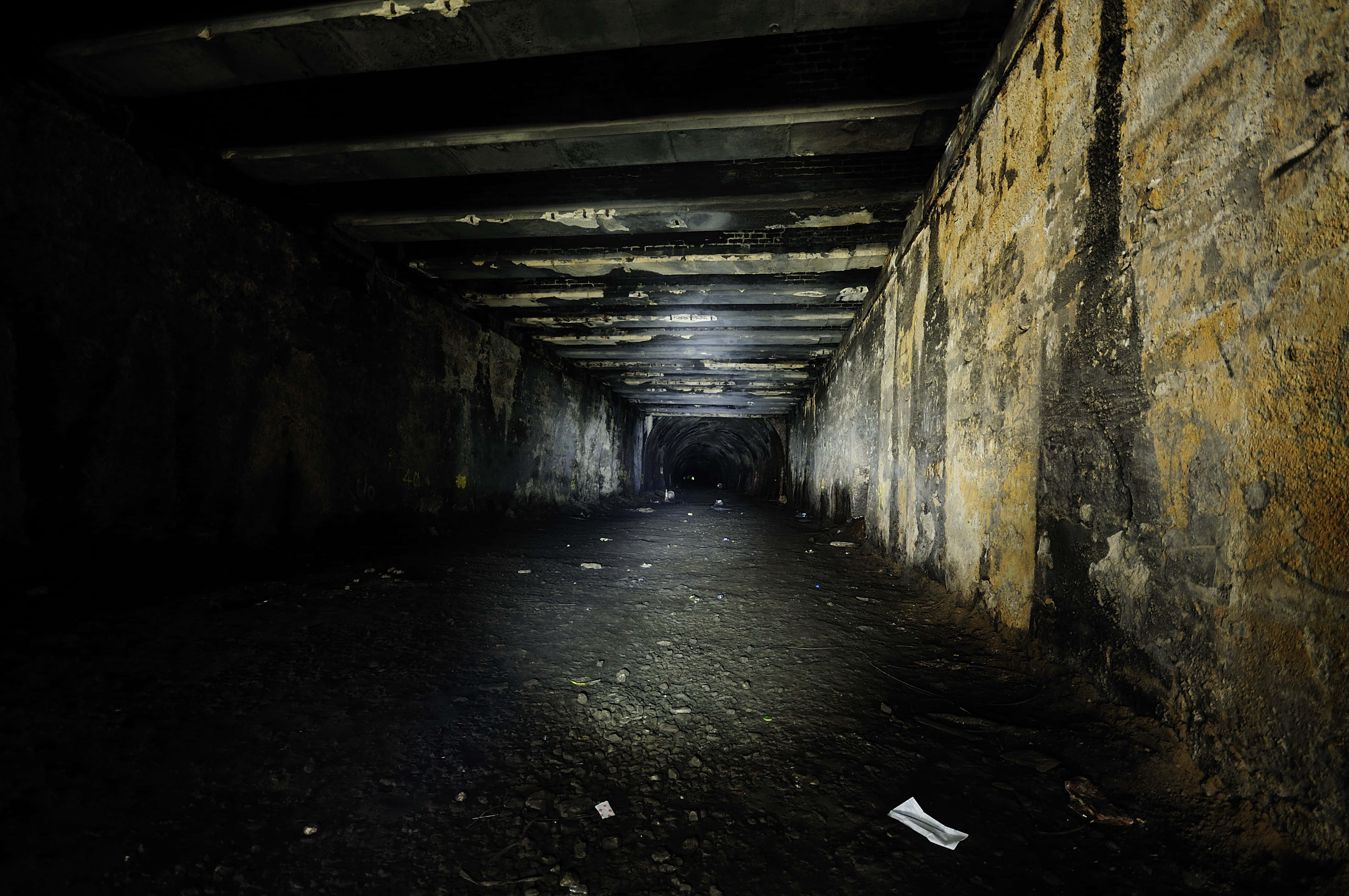 abandoned tunnel, crumbling concrete walls, scattered debris, 4K Desktop Wallpaper