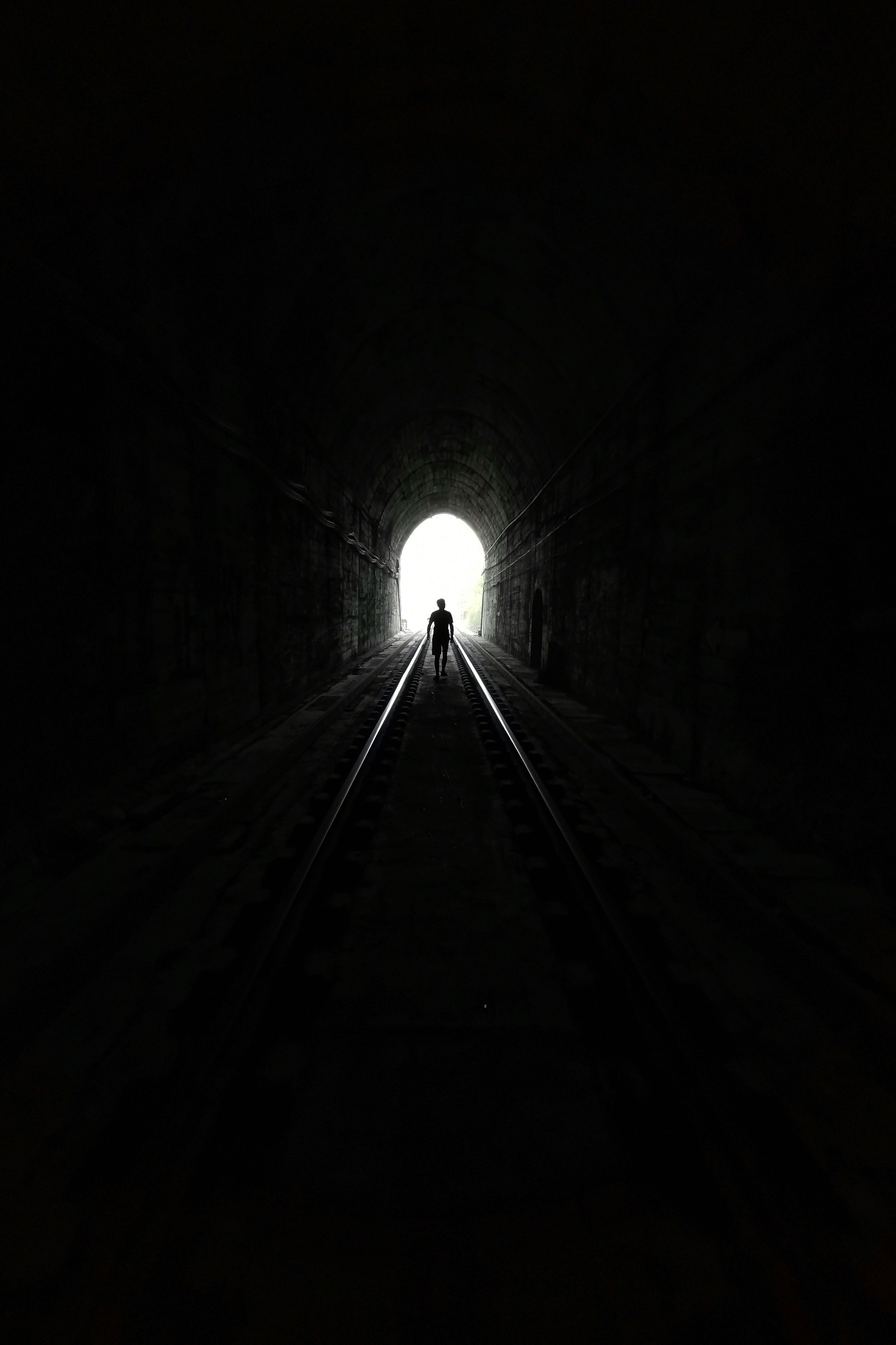 silhouette, light at the end of a dark railway tunnel, railway tunnel, 8K Phone Wallpaper