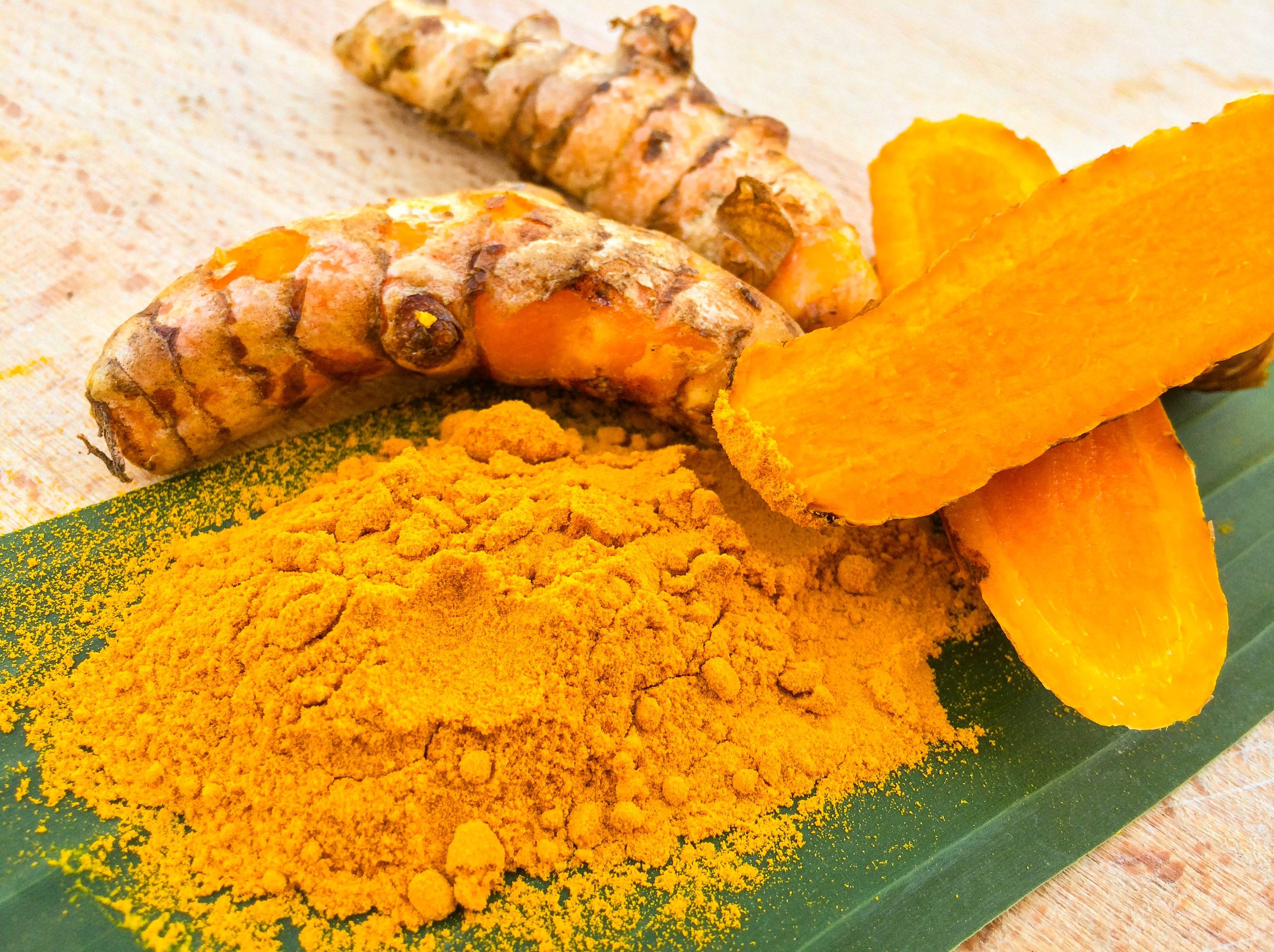 turmeric rhizomes, bright orange powder, green leaf, 2K Desktop Wallpaper