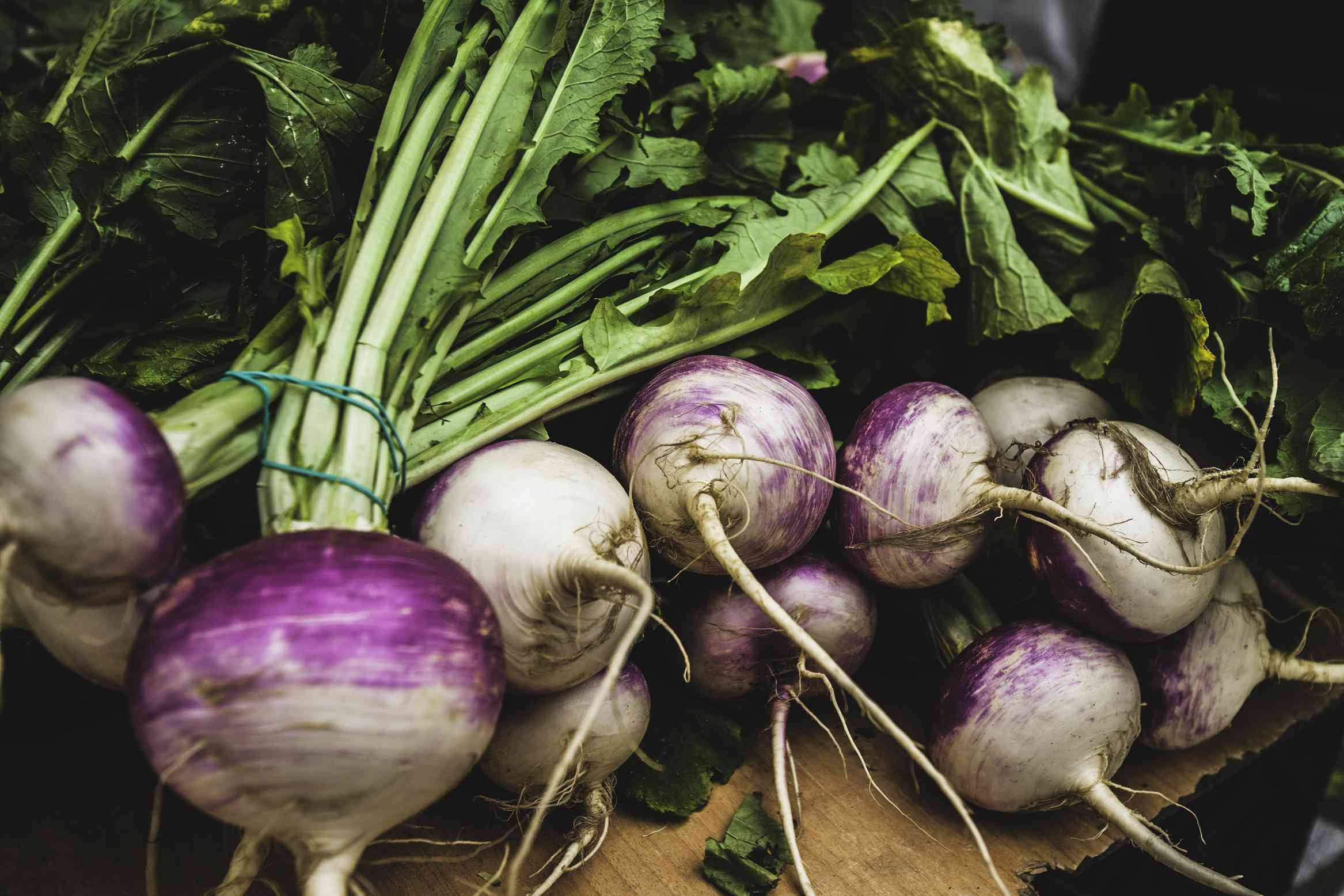 purple and white turnips, green stems, wooden surface, Full HD Desktop Wallpaper