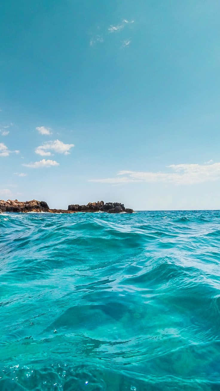 Turquoise iPhone, ocean waves, rocky island, HD Phone Wallpaper