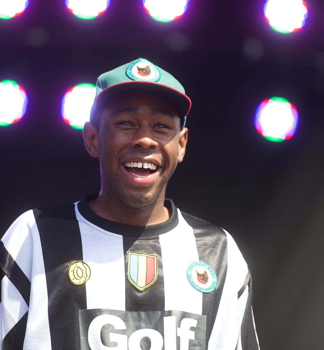 Tyler The Creator, black and white striped jersey, colorful stage lights, SD Phone Wallpaper