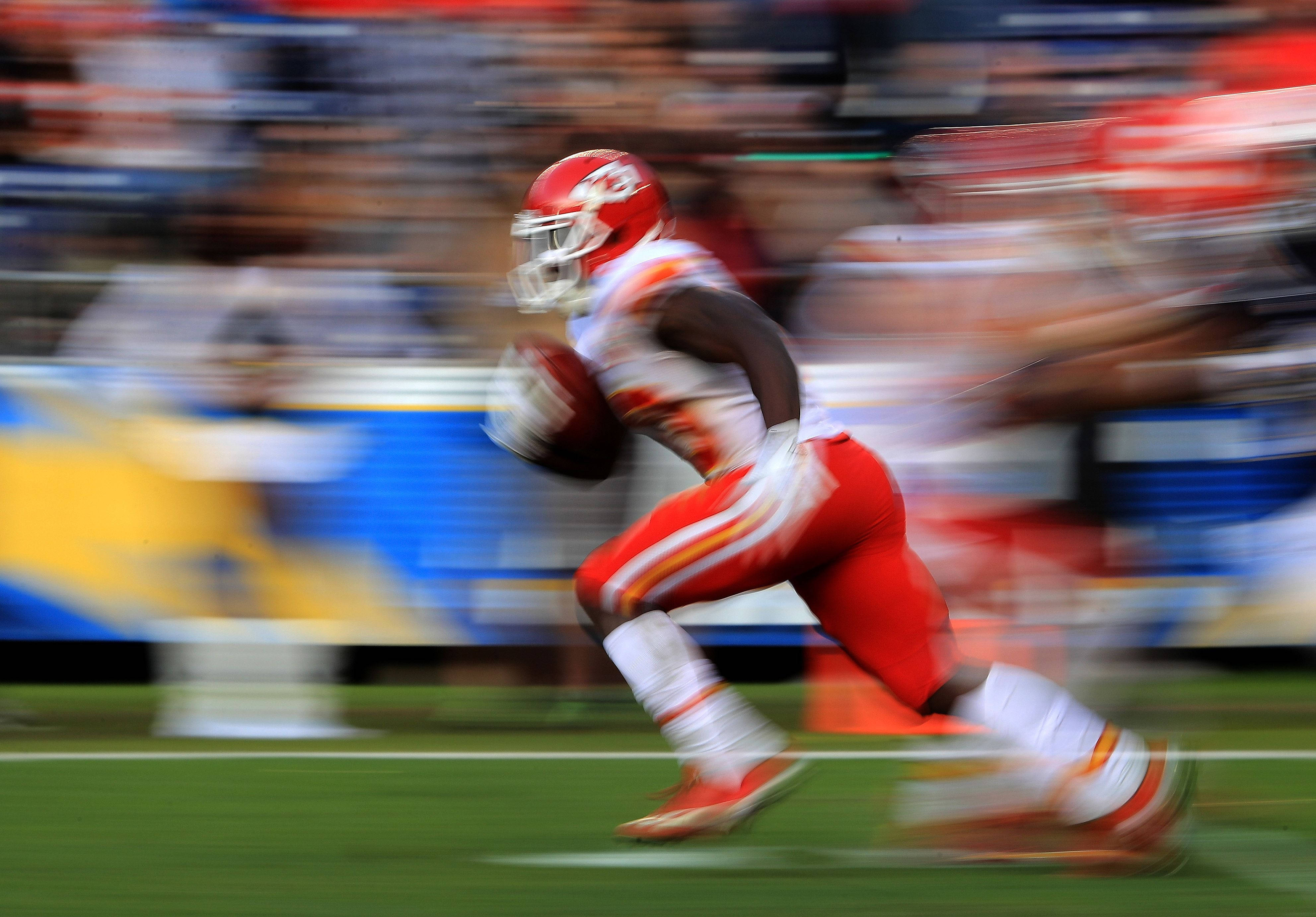 Tyreek Hill, red and white uniform, blurred stadium field, 4K Desktop Wallpaper