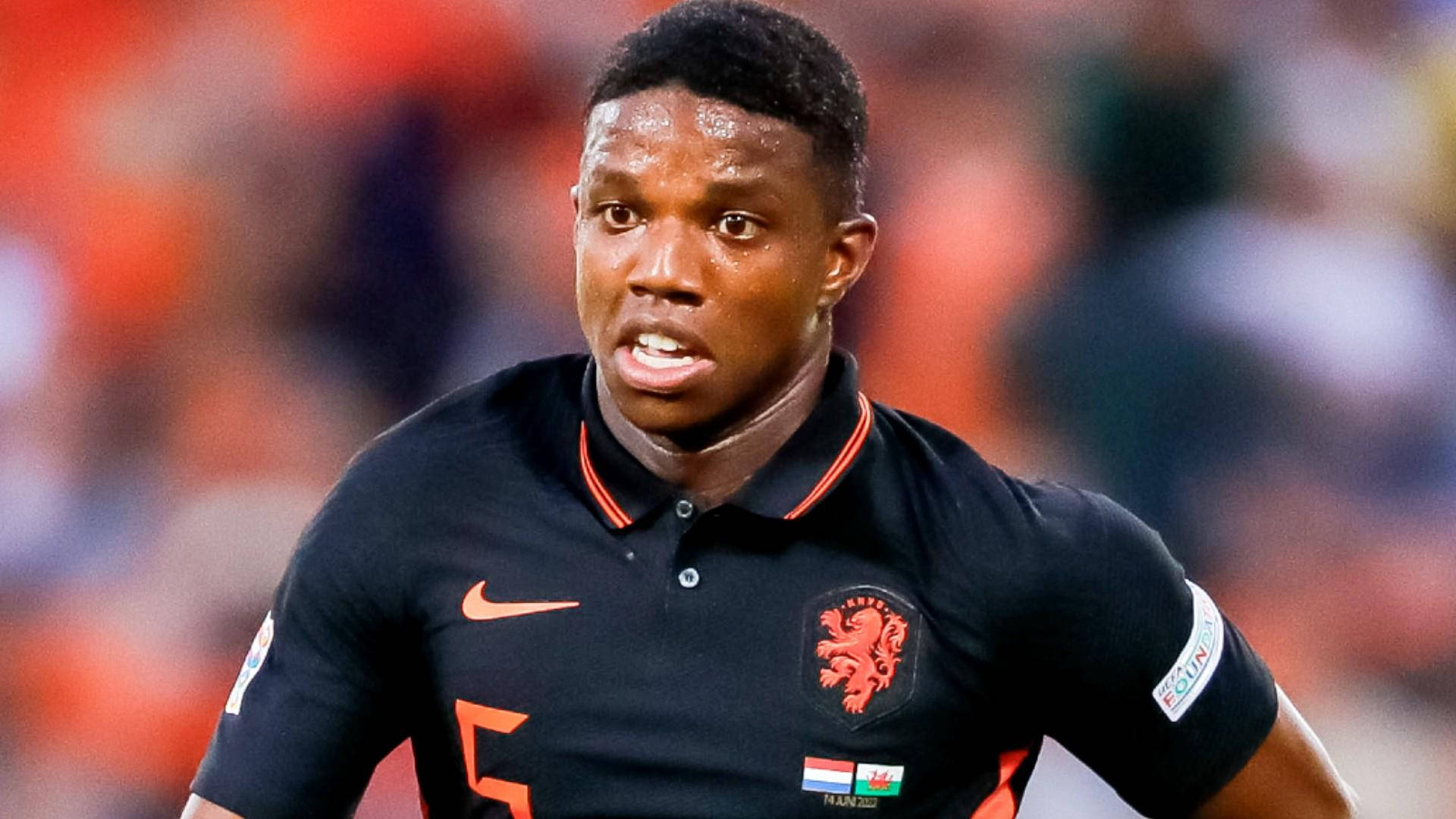 Tyrell Malacia, black jersey, orange accents, Full HD Desktop Wallpaper