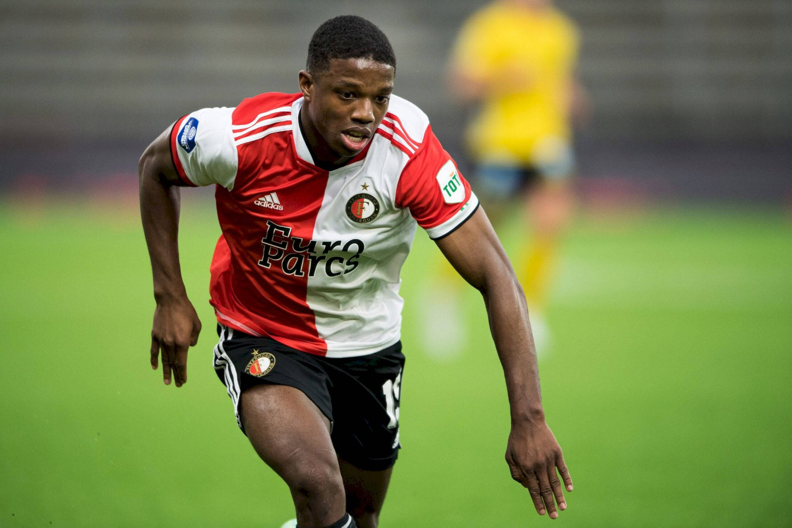 Tyrell Malacia, red and white striped jersey, vibrant green pitch, Full HD Desktop Wallpaper