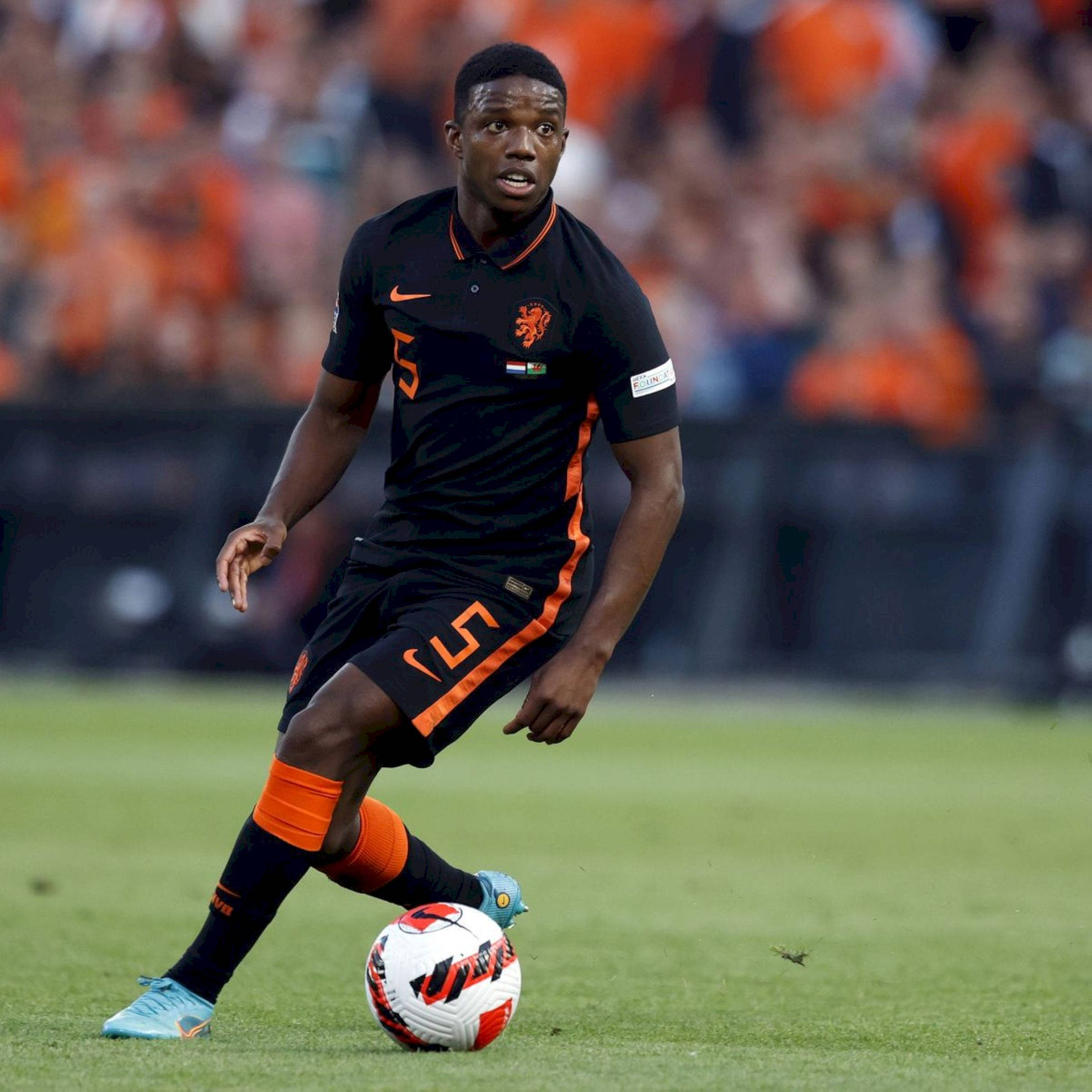 Tyrell Malacia, black and orange uniform, white and red ball, Full HD Desktop Wallpaper