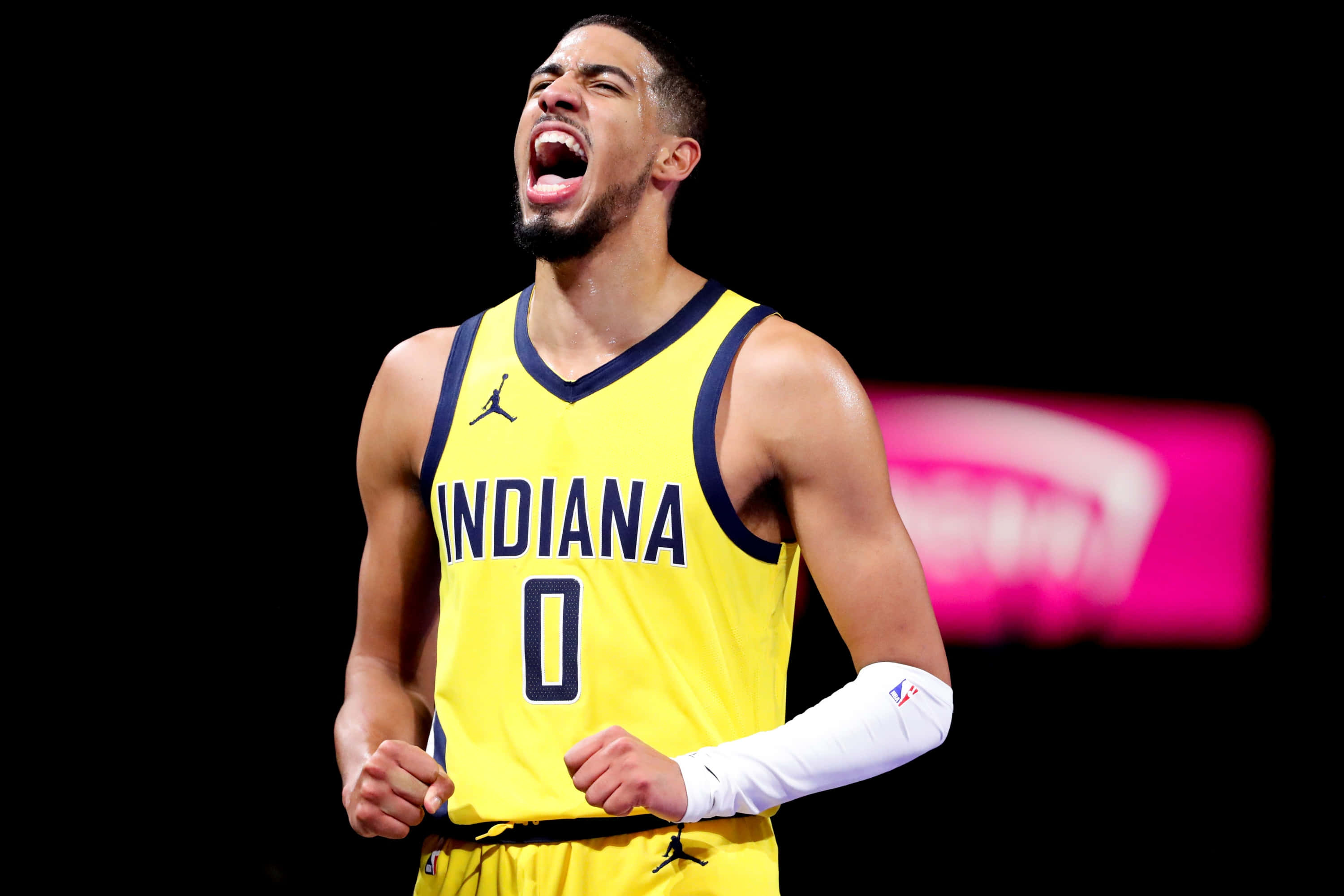 Tyrese Haliburton, yellow Indiana jersey, fists clenched, 2K Desktop Wallpaper