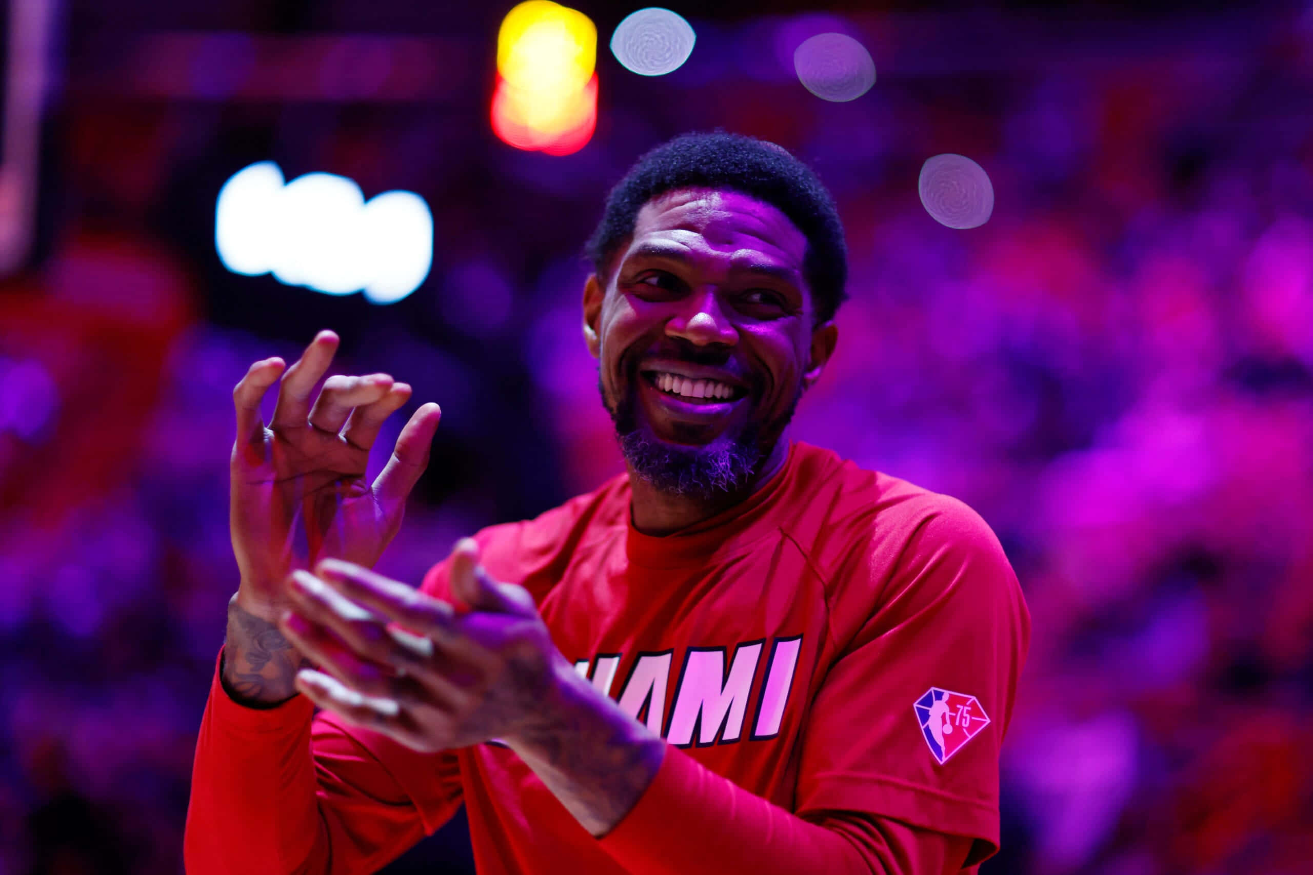 Udonis Haslem, red Miami jersey, vibrant purple and orange arena lights, 2K Desktop Wallpaper