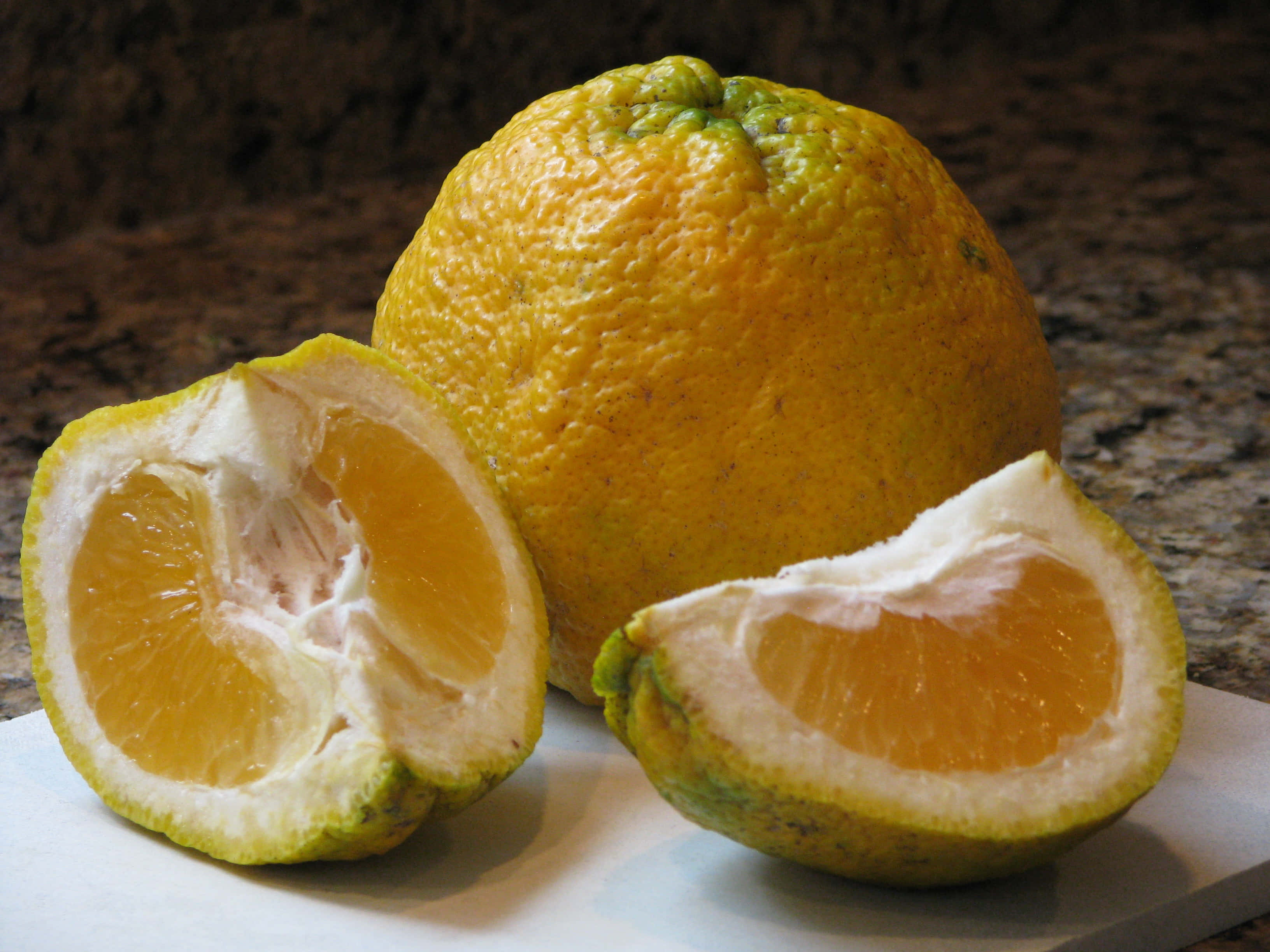 Ugli citrus fruits, vibrant orange pulp, textured peel, 2K Desktop Wallpaper