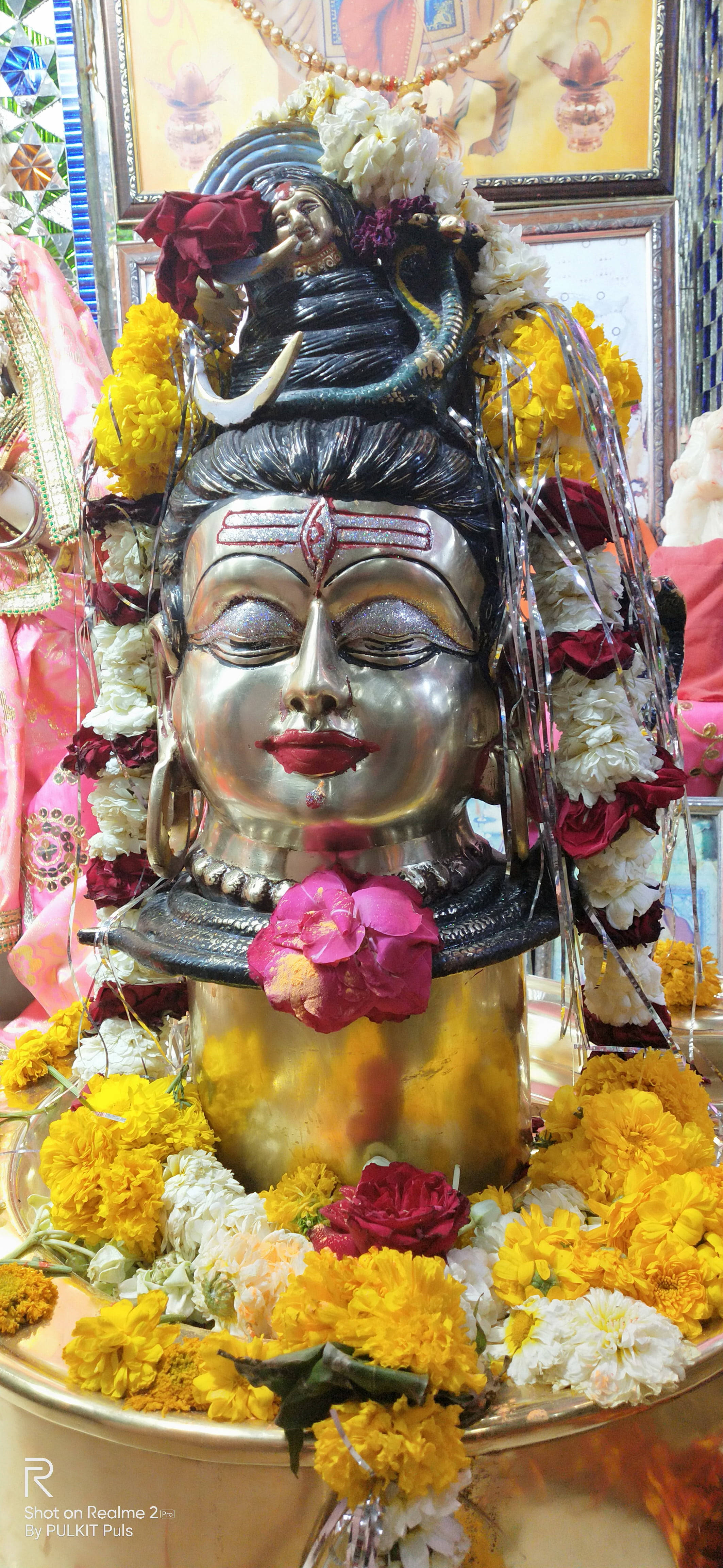 Ujjain Mahakal, yellow flowers, silver deity head, 4K Phone Wallpaper