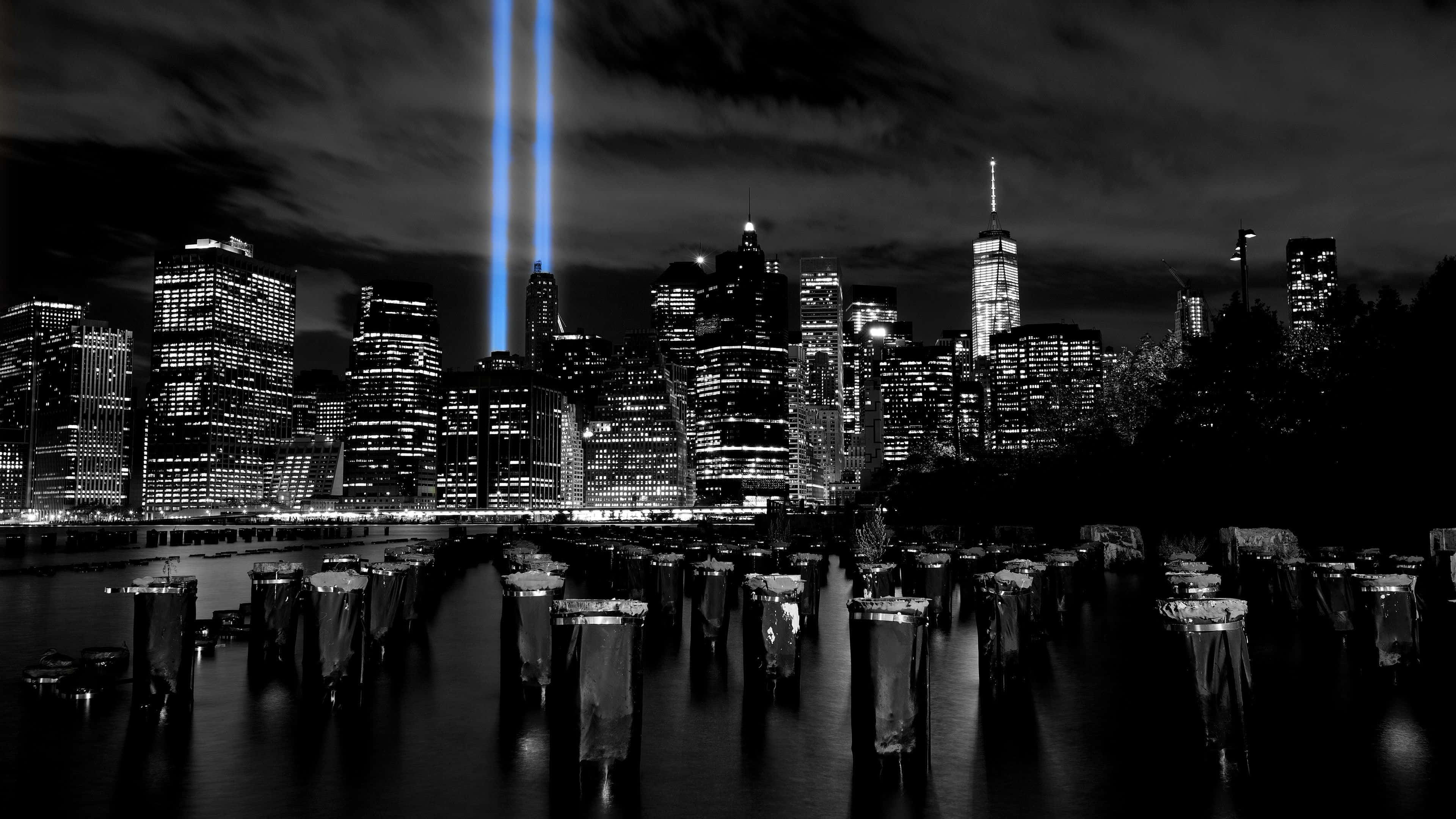 Black and white NYC skyline, night, two bright blue light beams, 4K Desktop Wallpaper