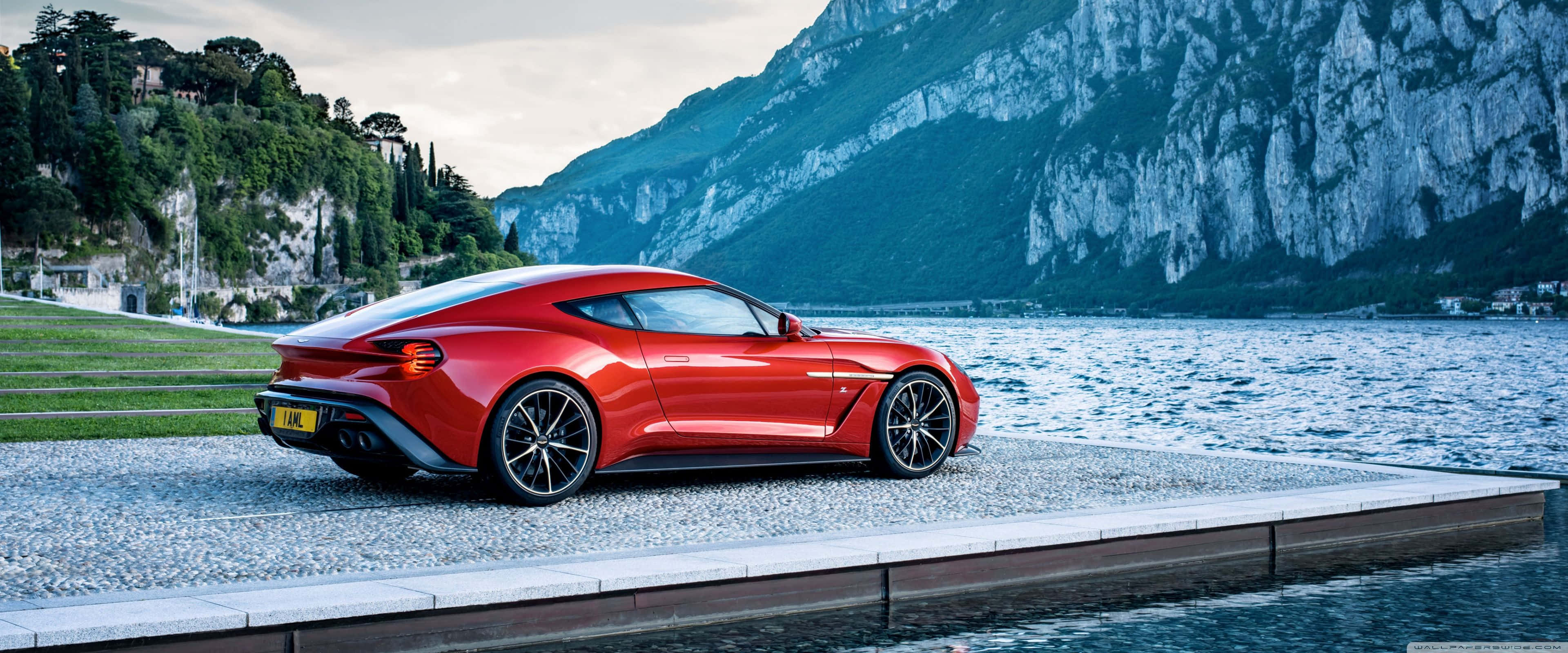 vibrant red sports car, stone pier, calm lake, 4K Desktop Wallpaper