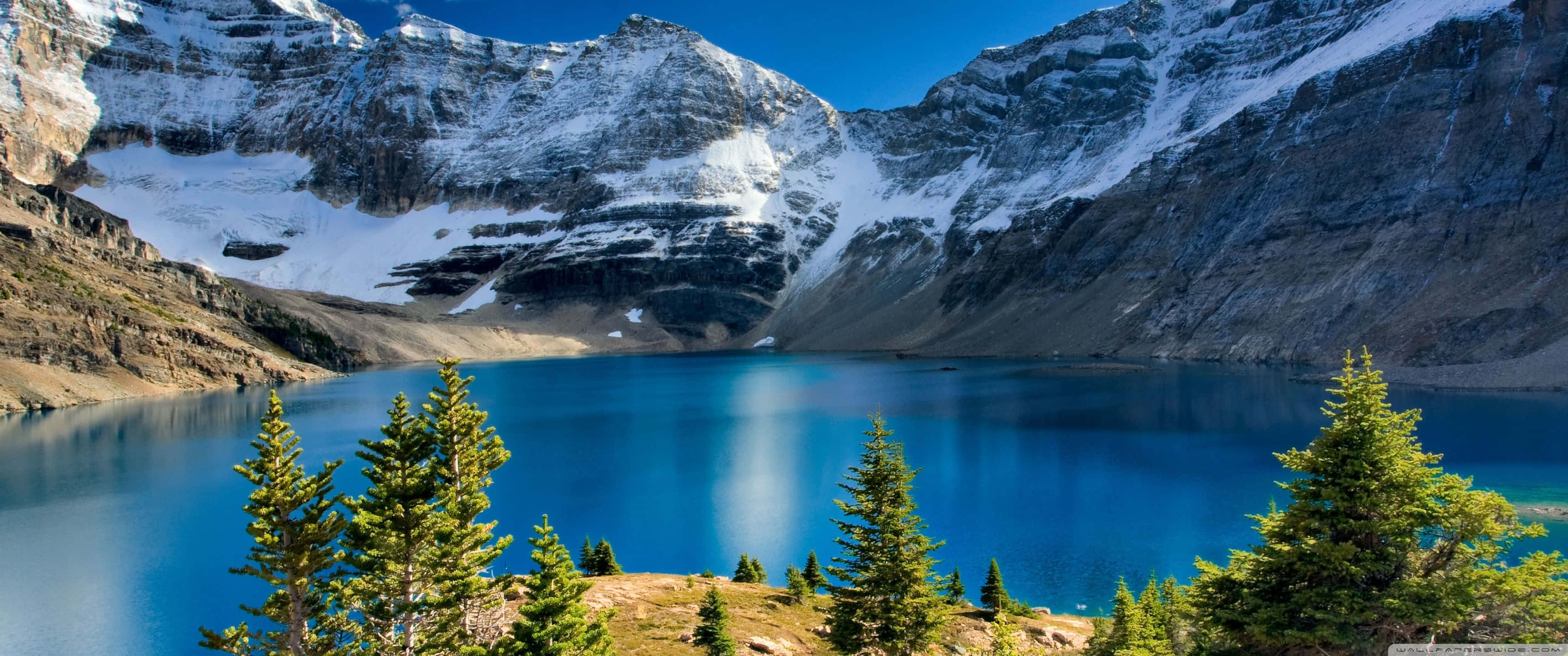 alpine lake, vibrant blue water, snow-capped mountains, 2K Desktop Wallpaper