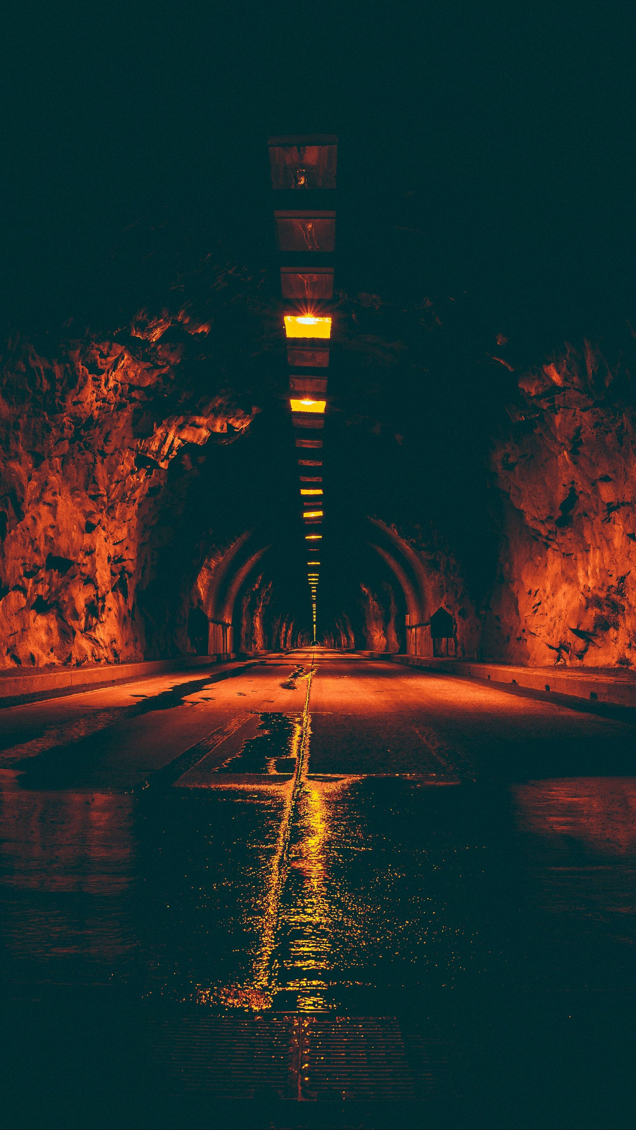 wet road, dark tunnel, warm orange lights, 4K Phone Wallpaper