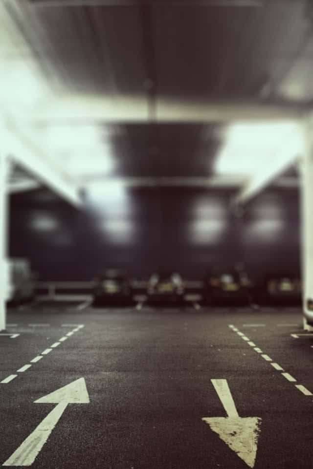 underground parking garage, faded white directional arrows, asphalt, SD Phone Wallpaper