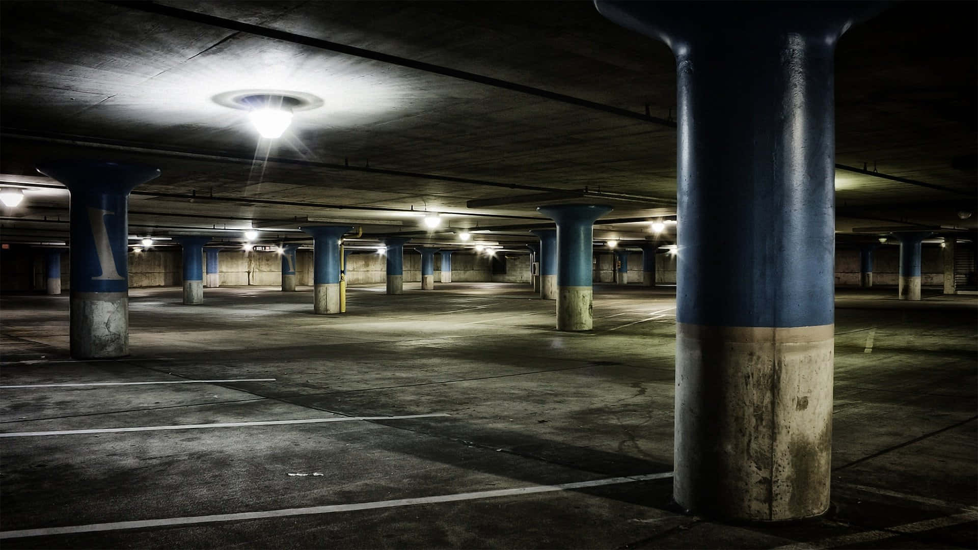 underground parking garage, concrete pillars, flickering overhead lights, Full HD Desktop Wallpaper