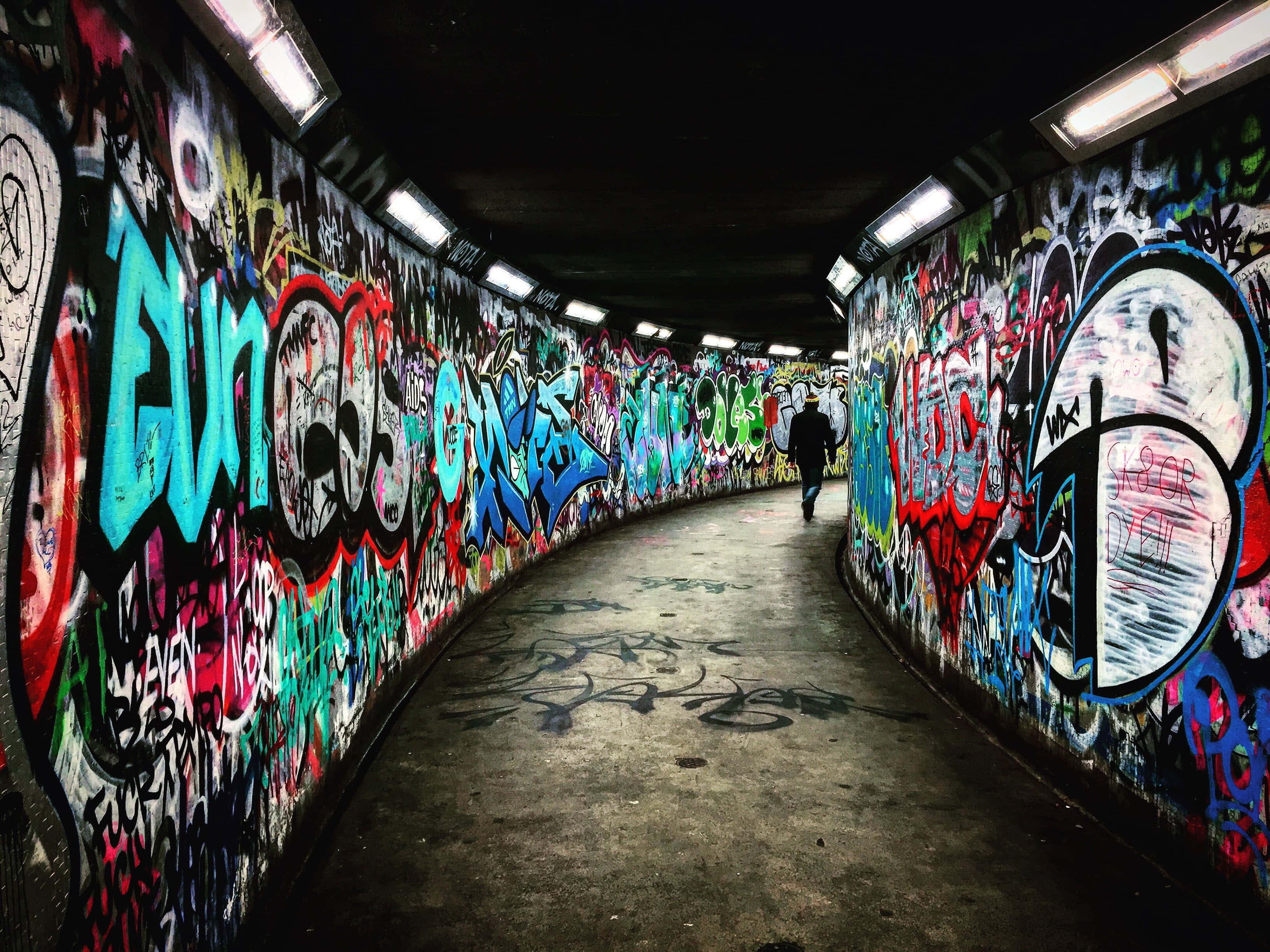 dark underground, curved tunnel, vibrant graffiti, 2K Desktop Wallpaper