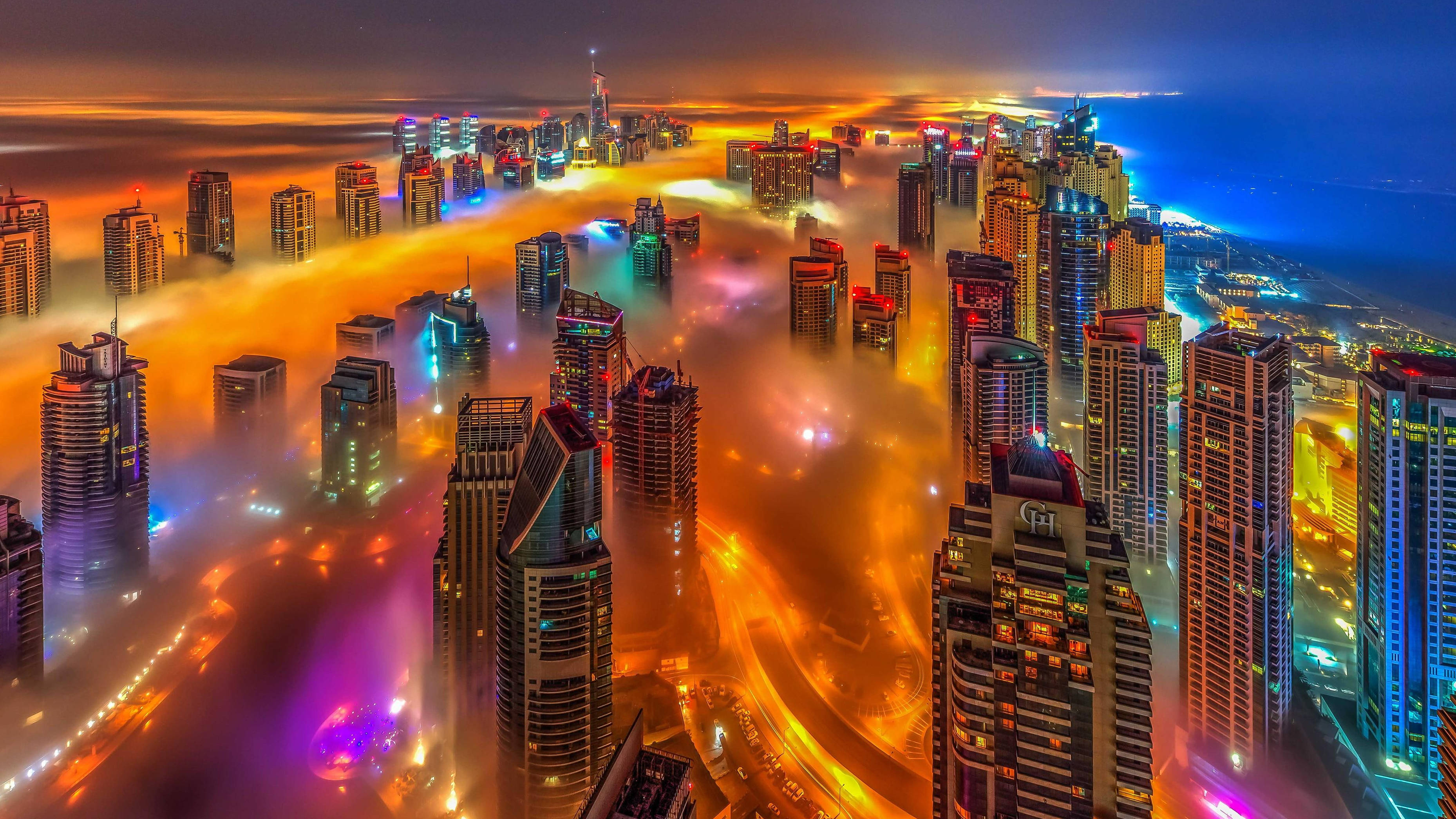 United Arab Emirates, futuristic city skyscrapers, glowing orange and purple clouds, 2K Desktop Wallpaper
