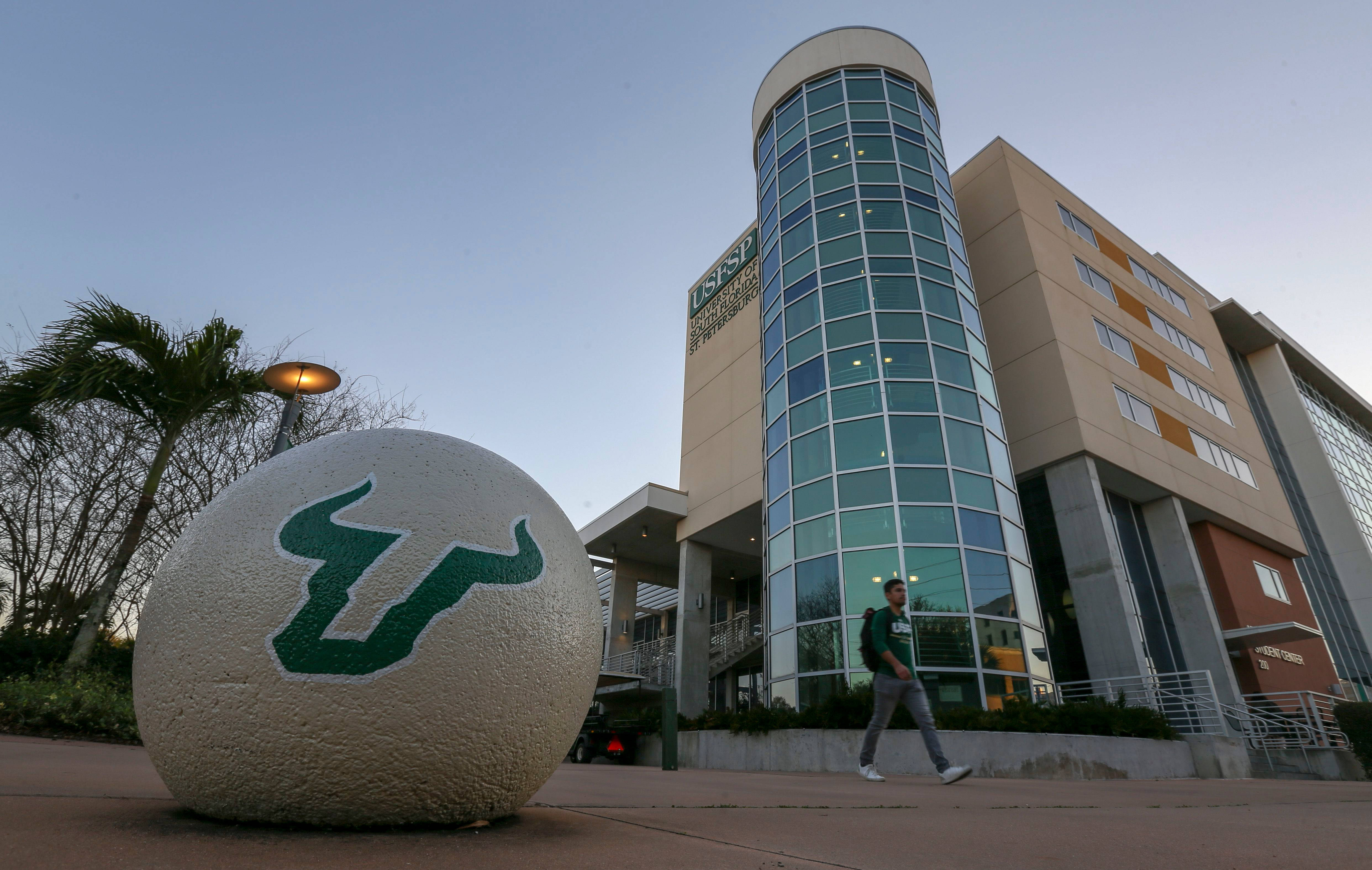 University Of South Florida, green bull logo, modern glass-and-beige university building, 4K Desktop Wallpaper