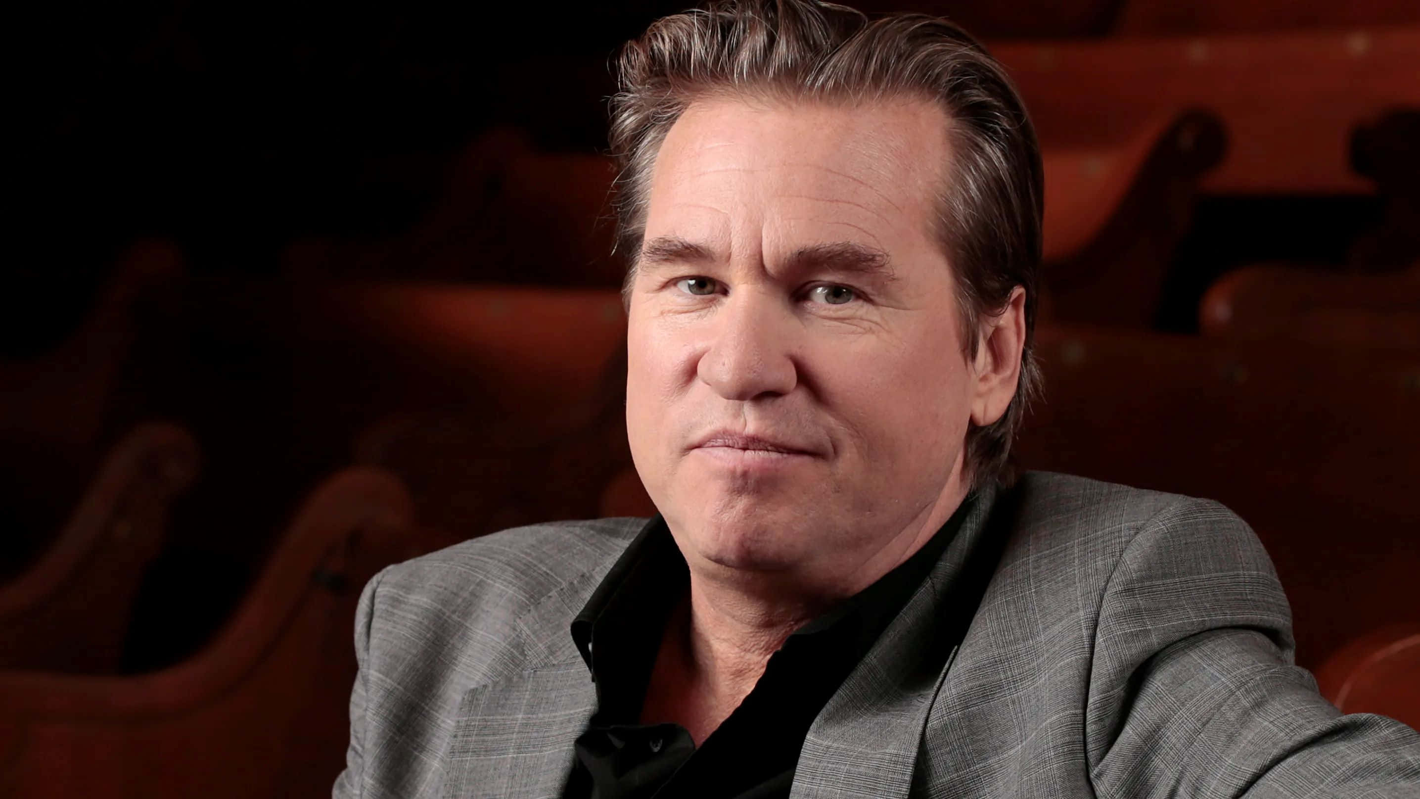Val Kilmer, gray suit, dimly lit theater, 2K Desktop Wallpaper