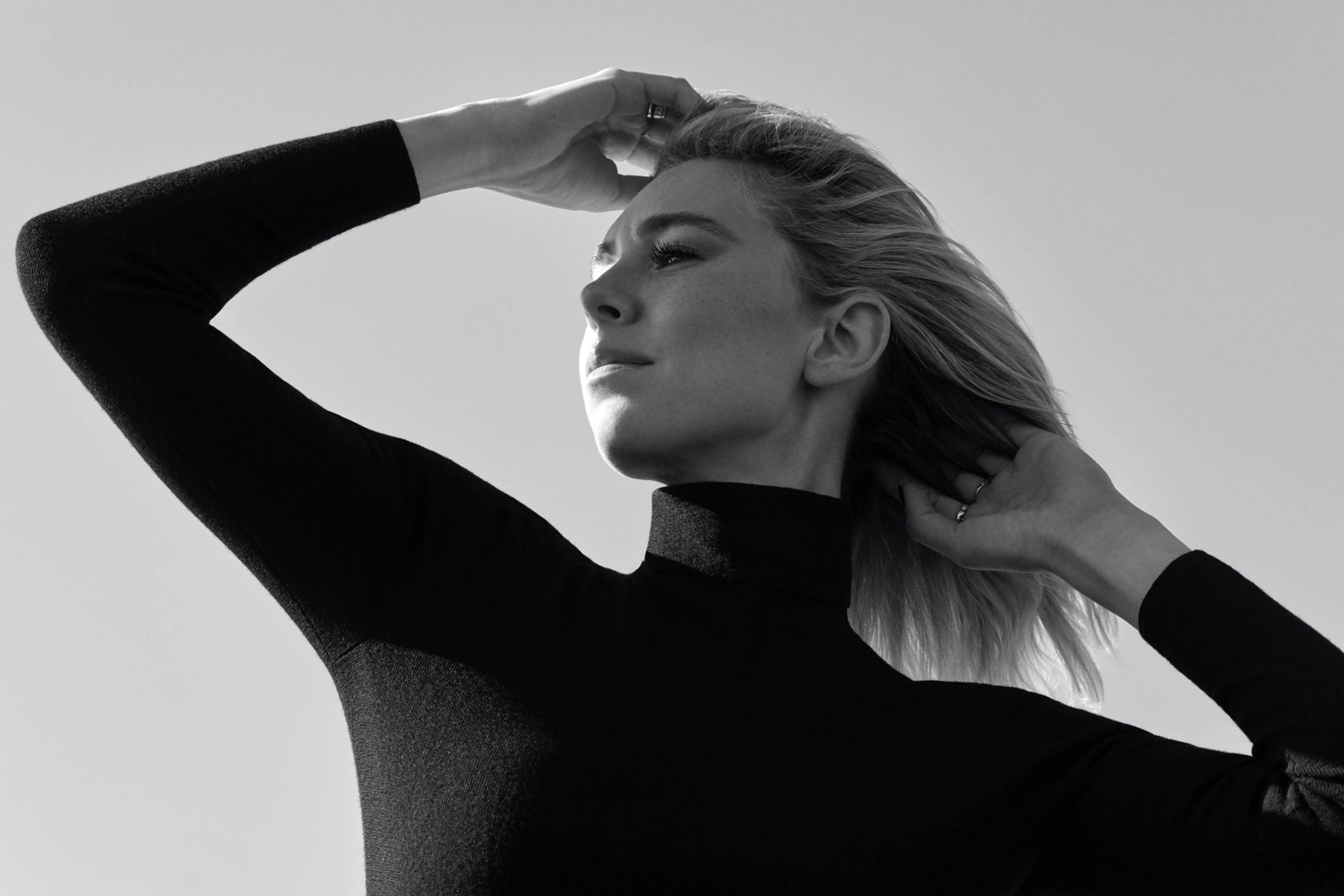 Vanessa Kirby, black turtleneck, plain light background, 2K Desktop Wallpaper