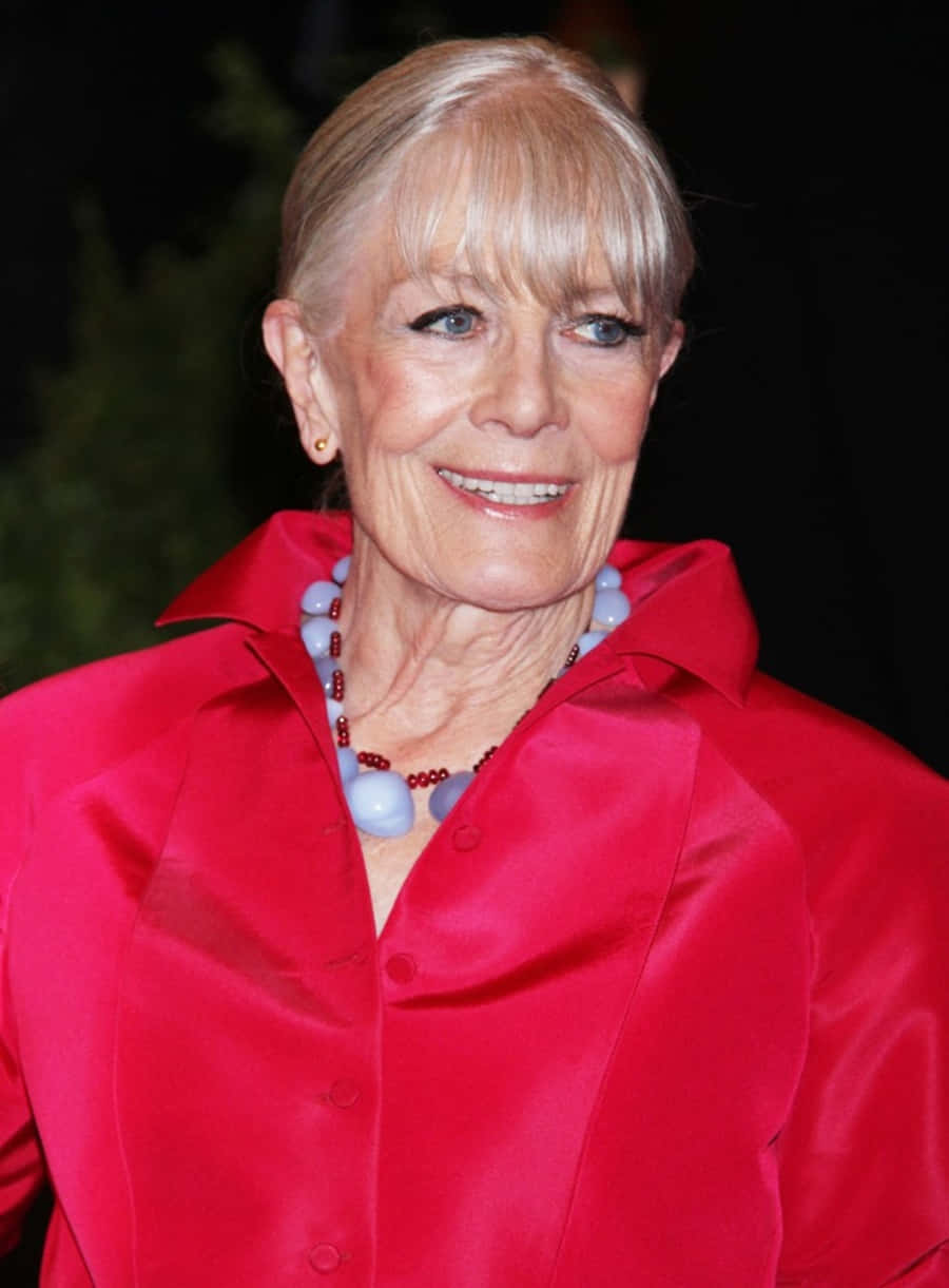 Vanessa Redgrave, vibrant red satin blouse, blue and red beaded necklace, SD Phone Wallpaper