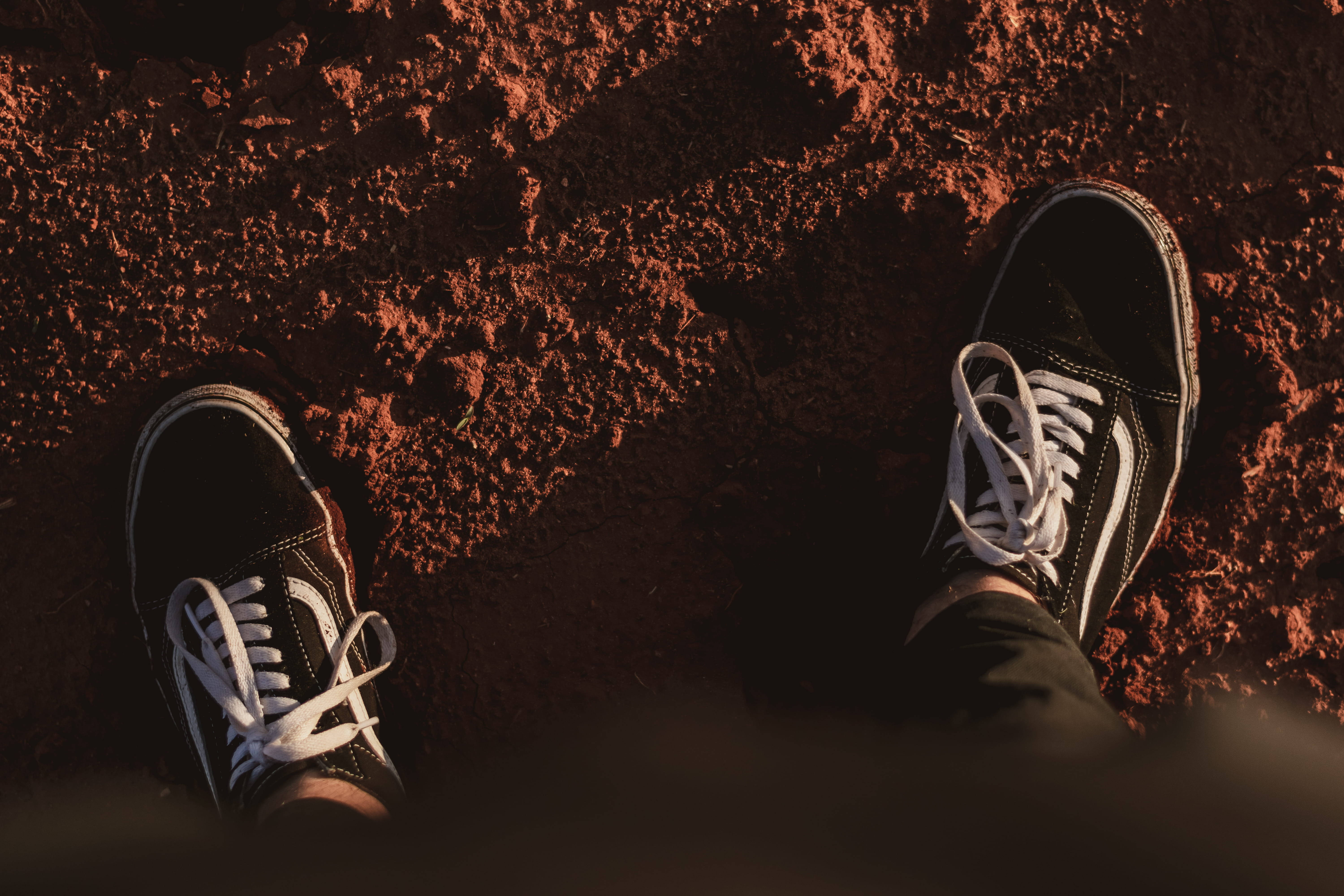 black Vans, black and white sneakers, textured reddish-brown dirt, 5K Desktop Wallpaper