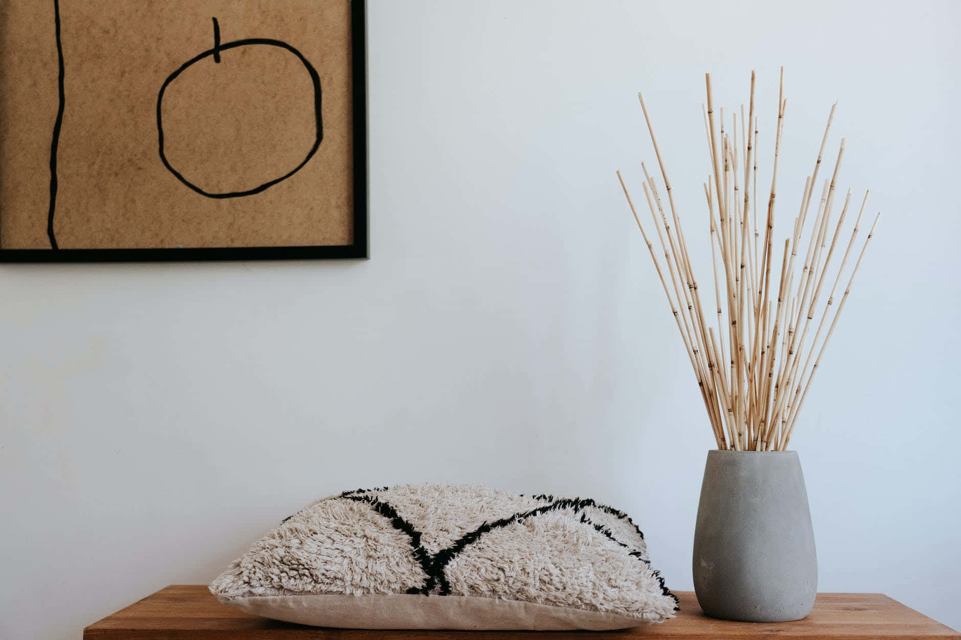 minimalist wooden shelf, textured beige pillow, black embroidery, HD Desktop Wallpaper