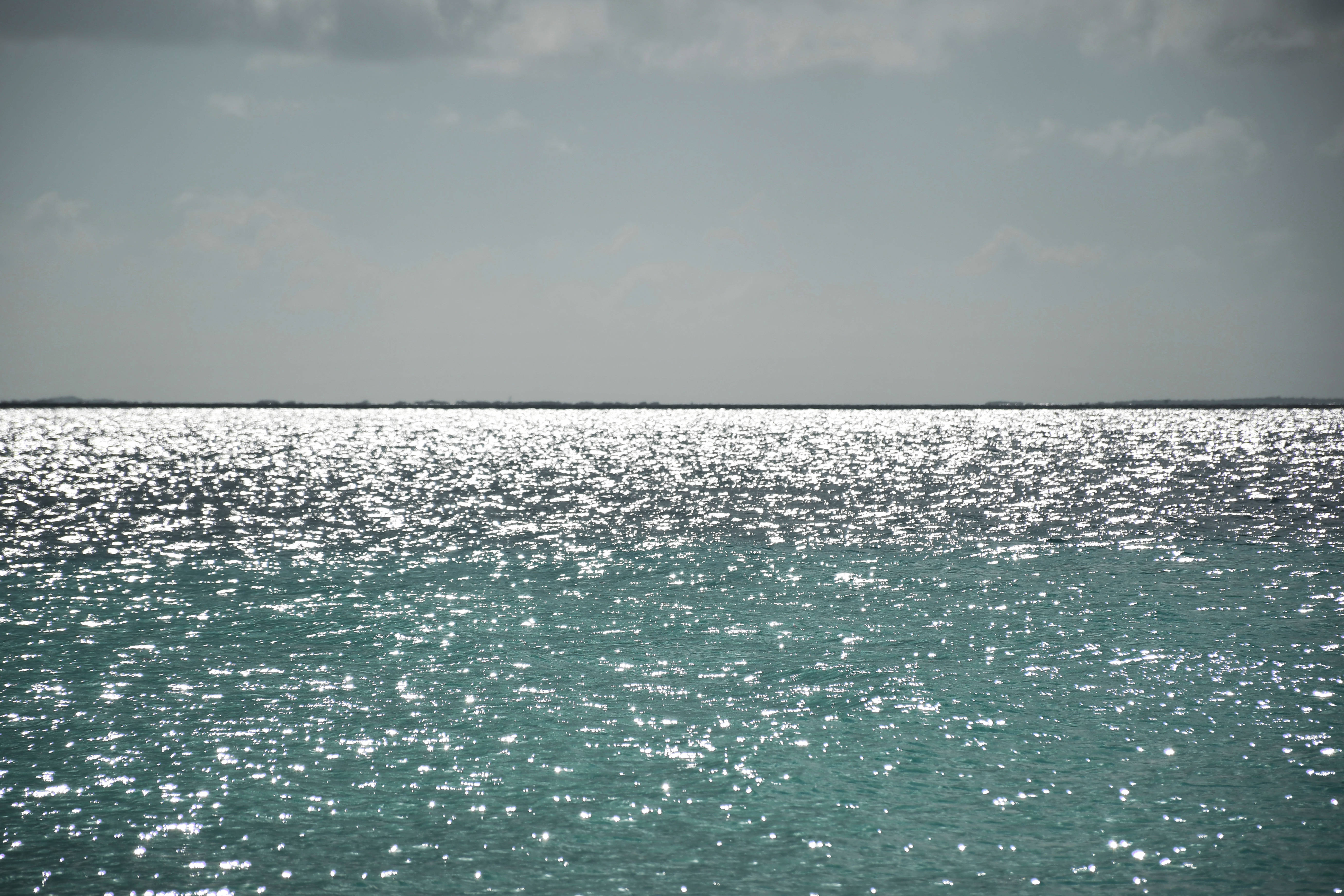 crystal water beach, turquoise waters, soft gray sky, 5K Desktop Wallpaper