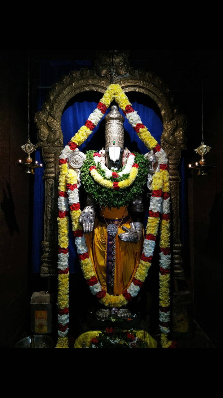 Venkateswara Swamy, silver deity statue, vibrant yellow red and white floral garlands, HD Phone Wallpaper