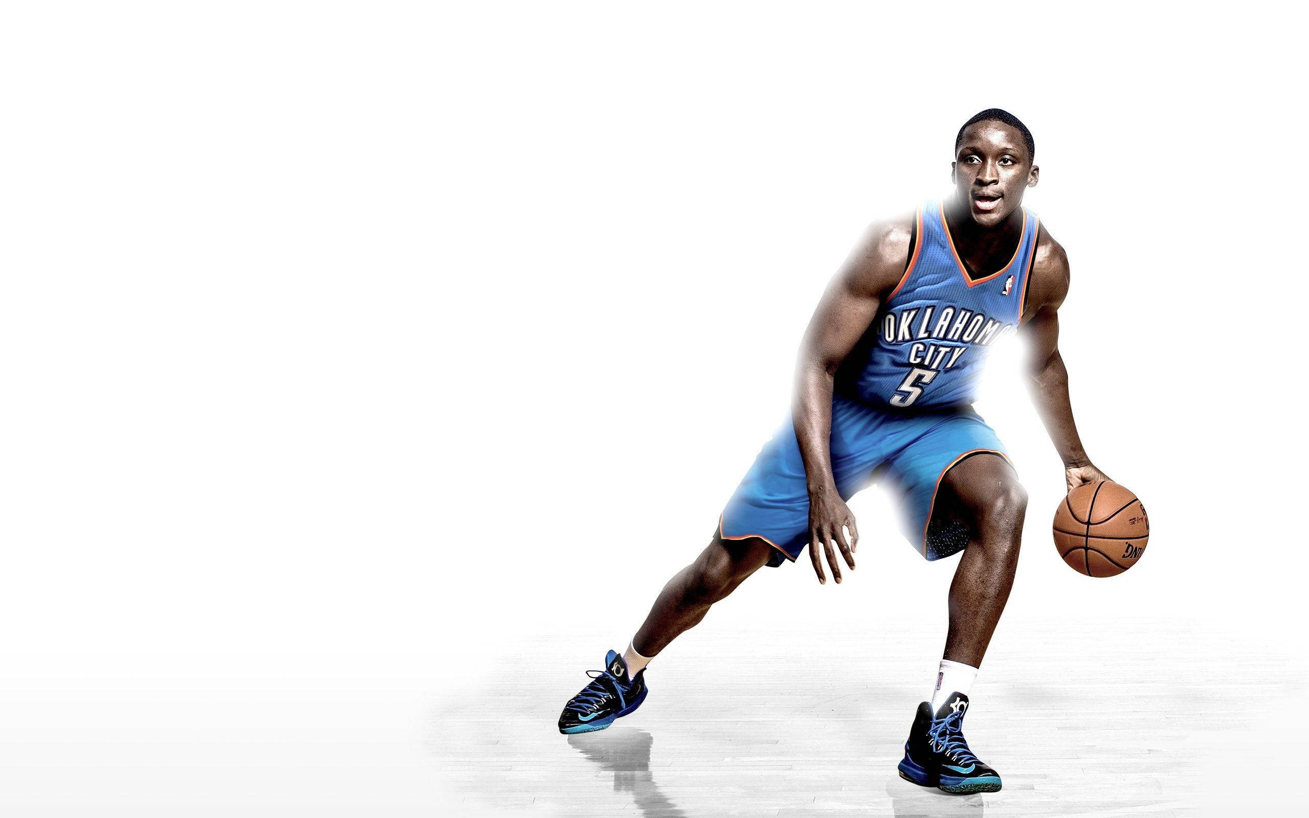 Victor Oladipo, blue Oklahoma City jersey, dribbles a ball, 2K Desktop Wallpaper