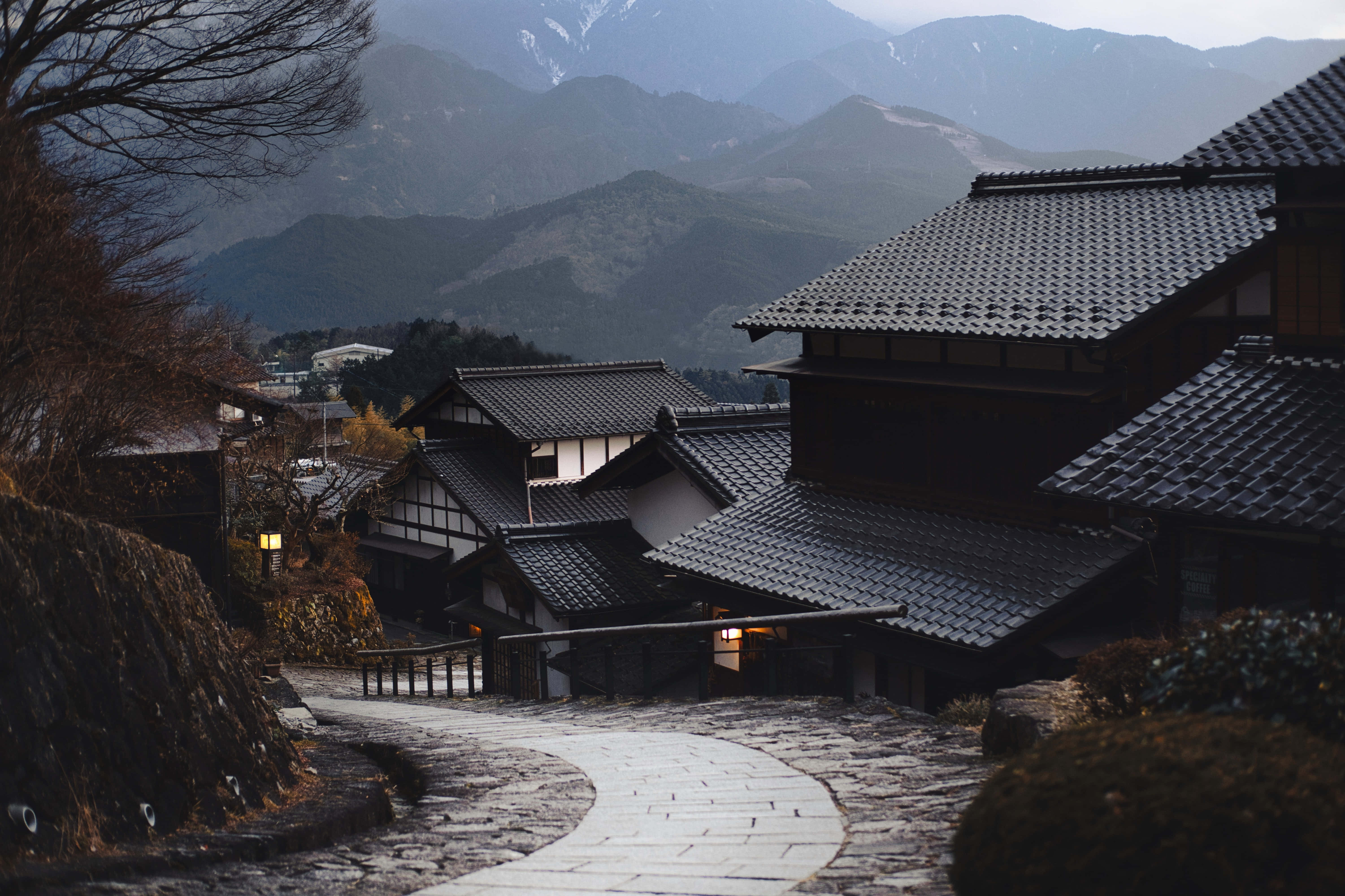 traditional Japanese rooftops, snow-capped mountains, misty background, 5K Desktop Wallpaper