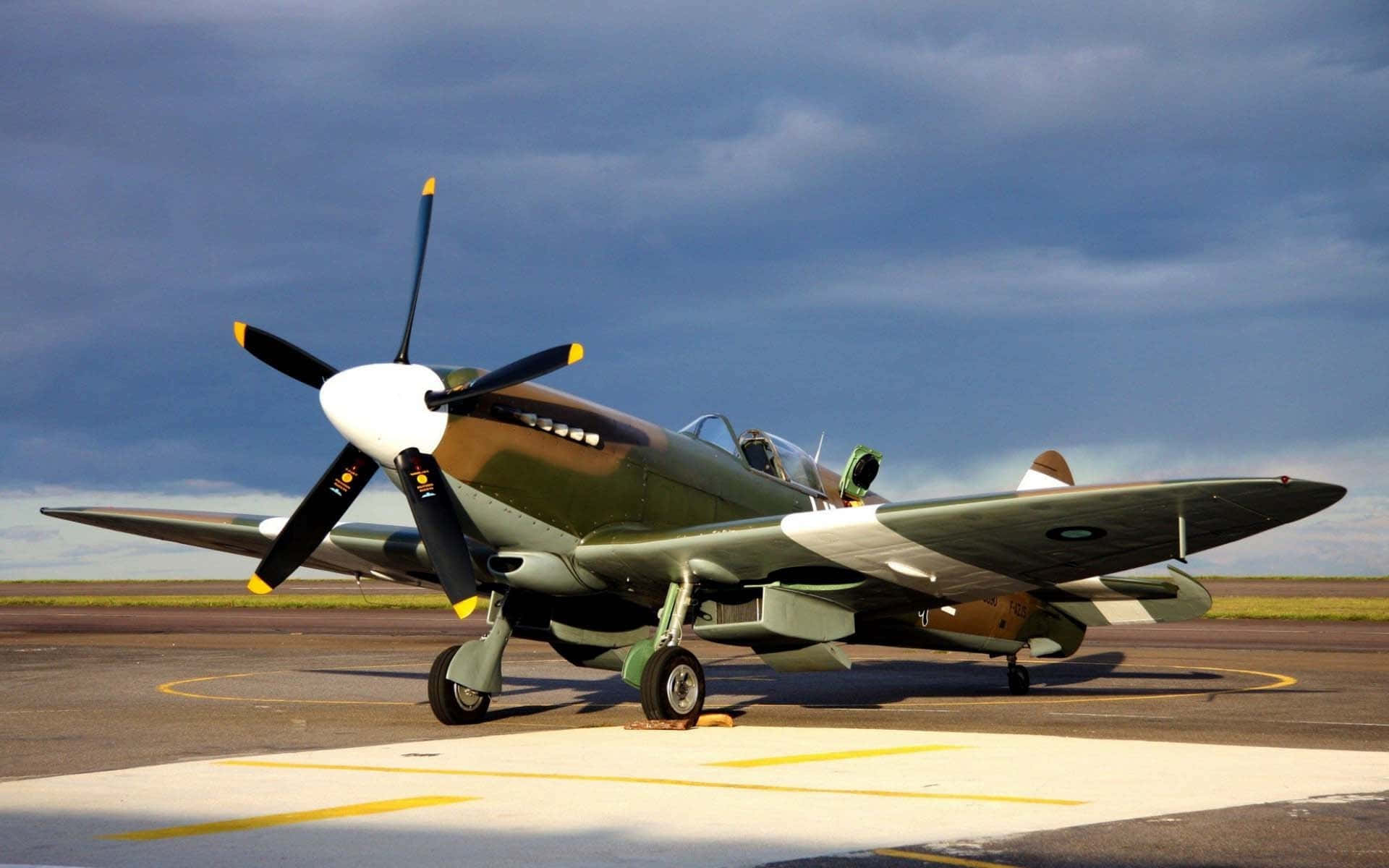 olive green fighter plane, yellow-tipped propeller, tarmac, Full HD Desktop Wallpaper