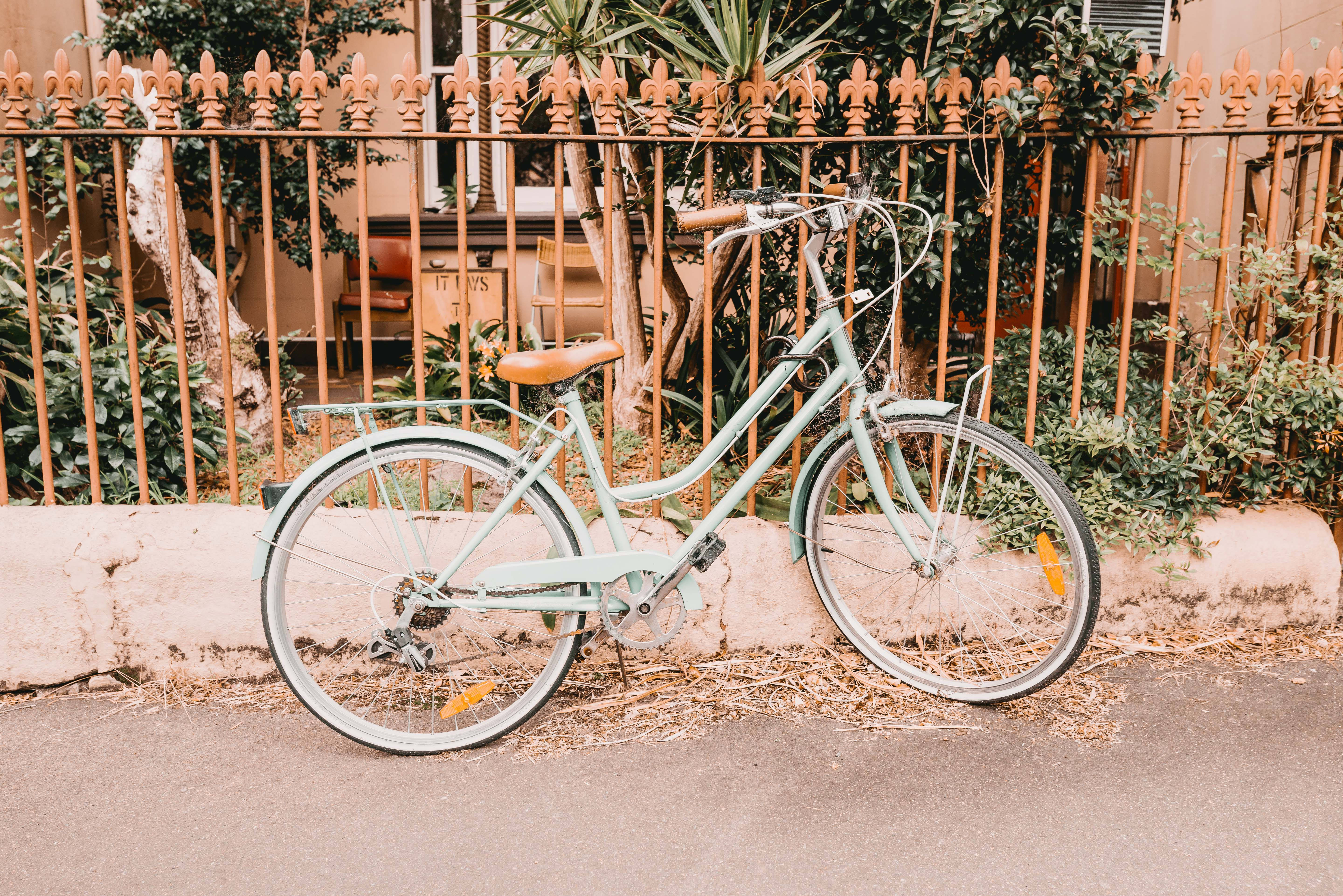mint green vintage bicycle, rusted ornate fence, sunlit sidewalk, 5K Desktop Wallpaper