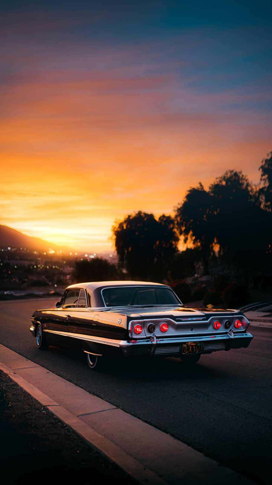 classic black and silver car, glowing red taillights, street at sunset, HD Phone Wallpaper