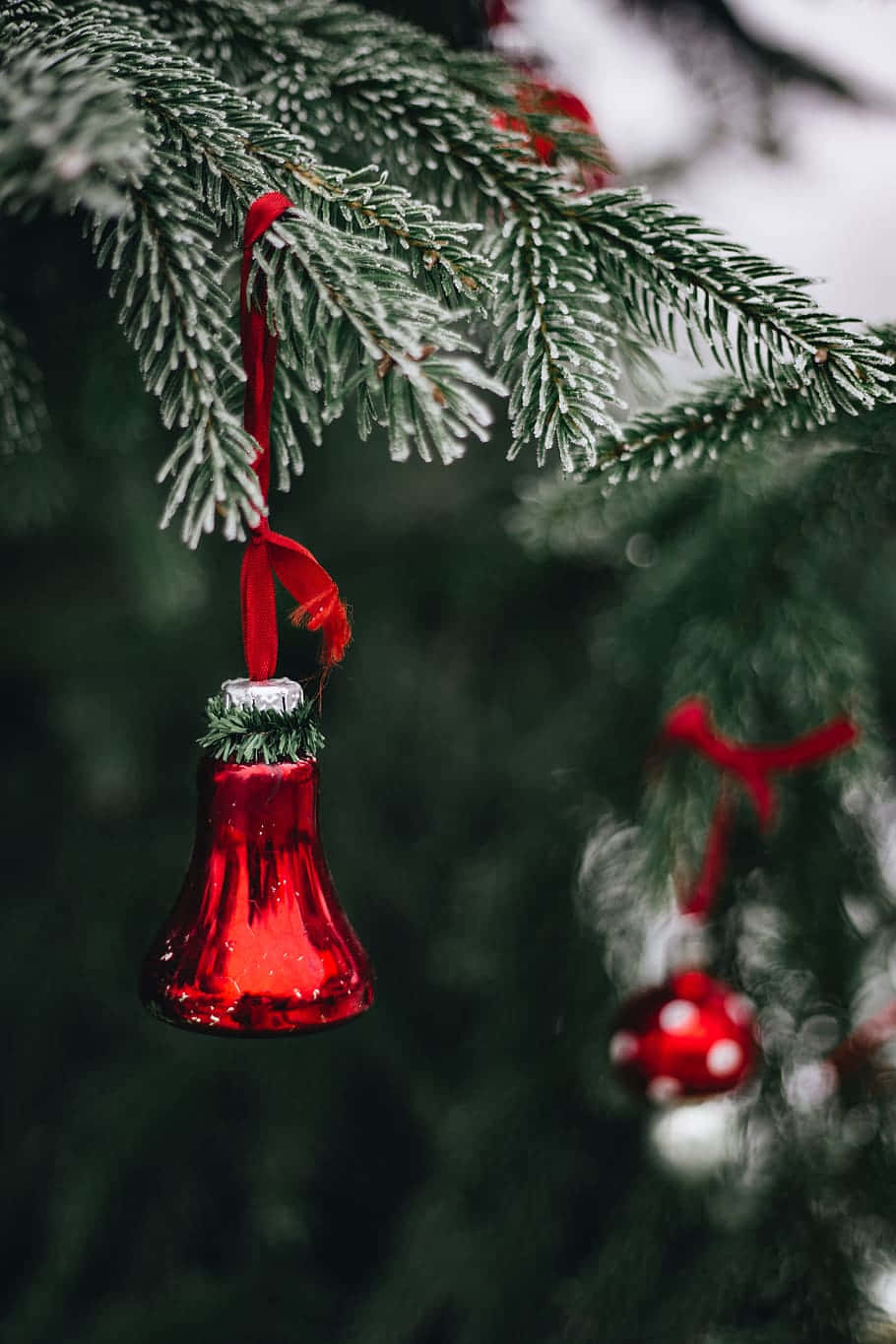 red glass bell ornament, snow-dusted fir branch, red ribbon, HD Phone Wallpaper