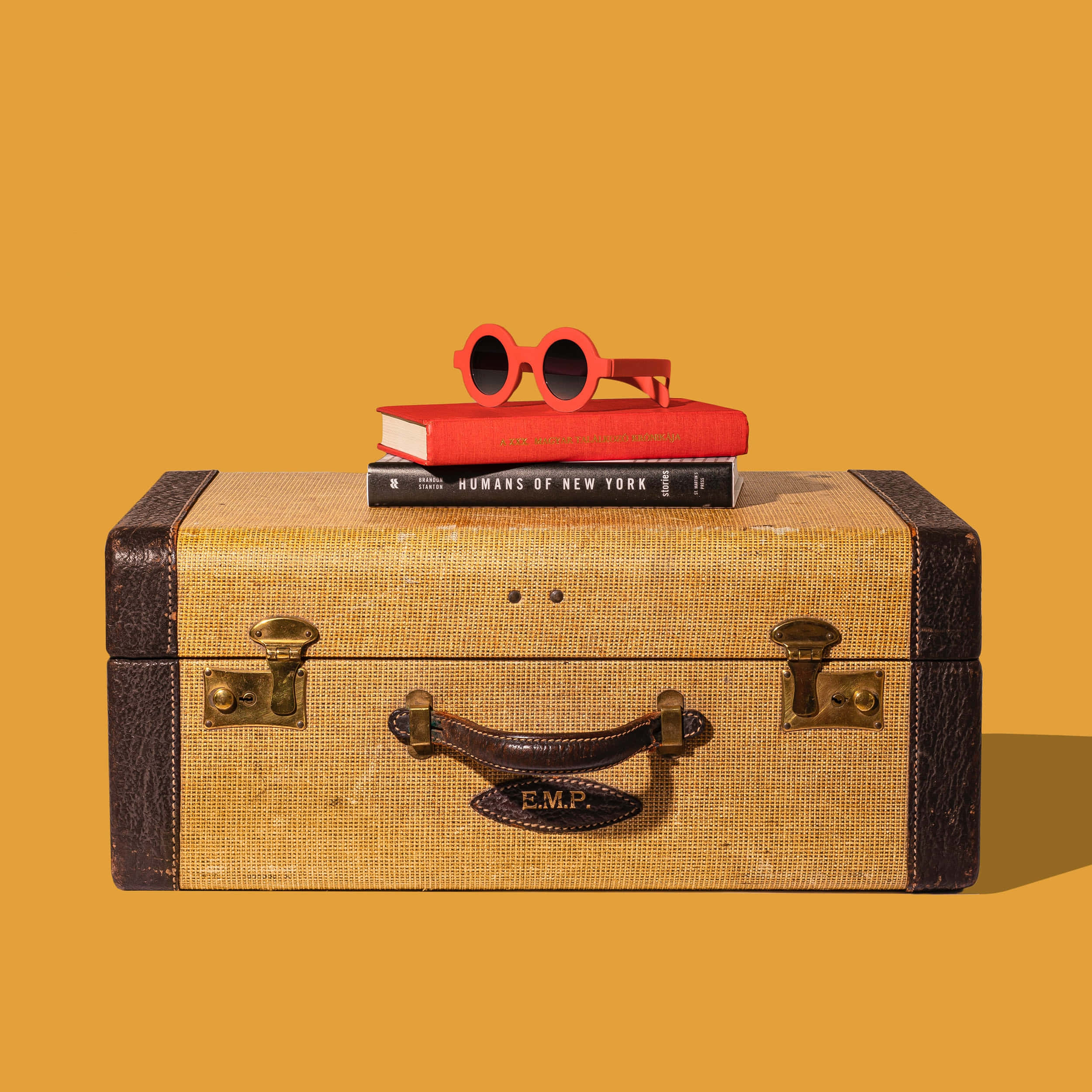 vintage textured suitcase, bold red sunglasses, solid mustard yellow background, Full HD Desktop Wallpaper