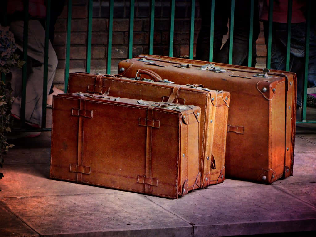 antique brown leather suitcases, sidewalk, green metal fence, SD Desktop Wallpaper