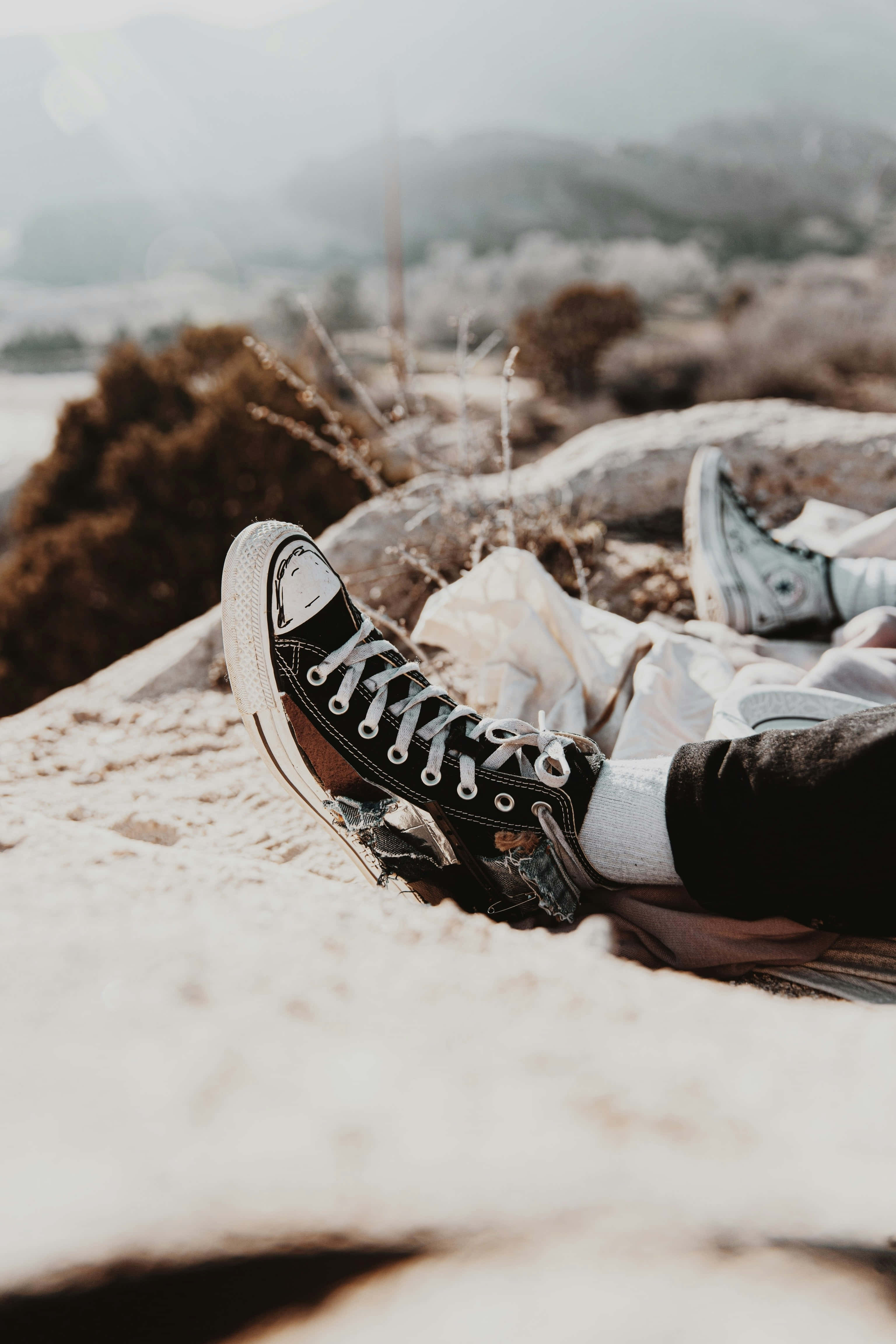 black Converse sneakers, snowy rocks, hazy mountain landscape, 4K Phone Wallpaper